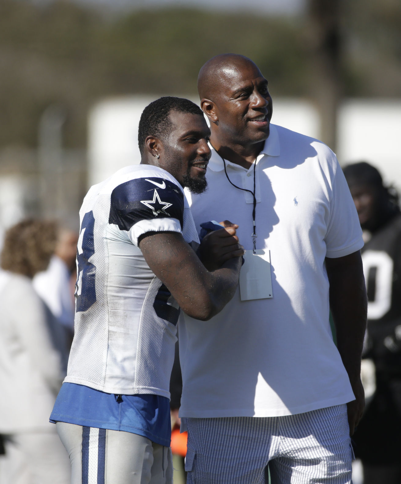 Dallas Cowboys wide receiver Dez Bryant, left, and Los Angeles Dodgers part-owner Magic Johnson pause for photos during the team's joint football practice with the Oakland Raiders on Tuesday, Aug. 12, 2014, in Oxnard, Calif. (AP Photo/Jae C. Hong) (Jae C. Hong)