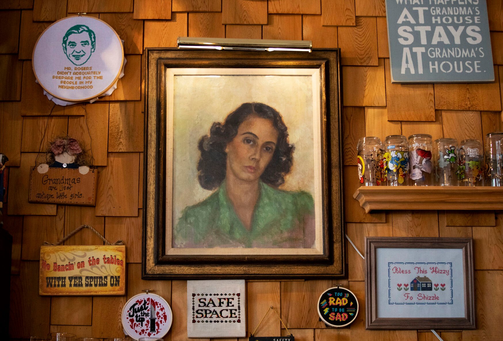 A self-portrait painting of owner Matthew Fuerst’s grandmother, Franca, at Grandma’s House in July 2021. Her paintings decorate the walls of the taproom. (Chancey Bush, Gazette file)