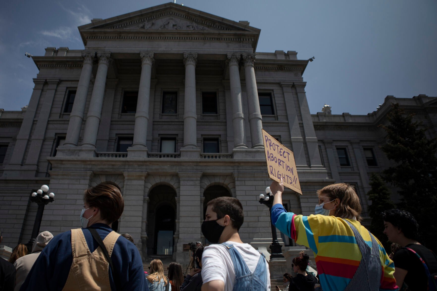 Sev Armstrong holds up a sign during an abortion-rights protest on Tuesday, May 3, 2022, on the west steps of the state Capitol building in Denver, Colo. (Timothy Hurst/The Denver Gazette) (Timothy Hurst)