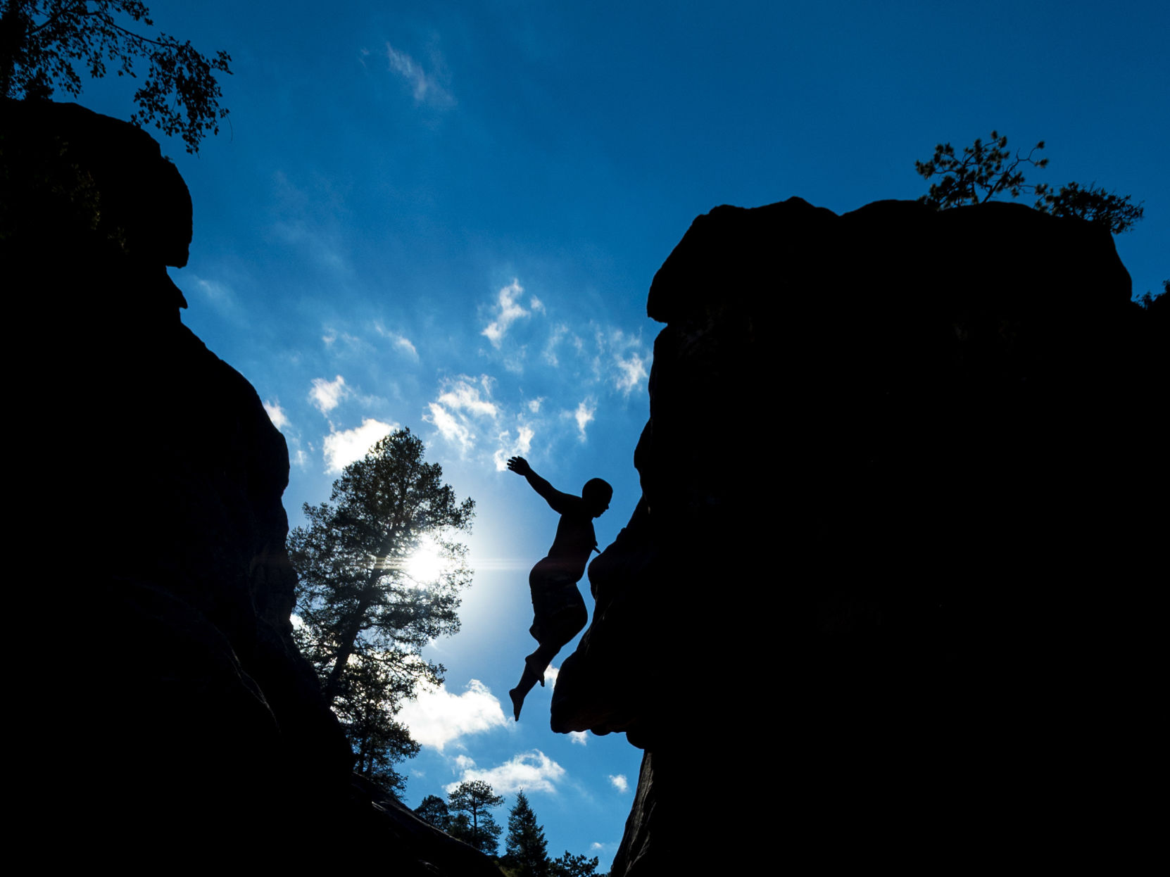 Jake Allen of New Jersey jumps off the cliffs at Paradise Cove in Guffey, Colo., Saturday, June 24, 2017. (The Gazette file)