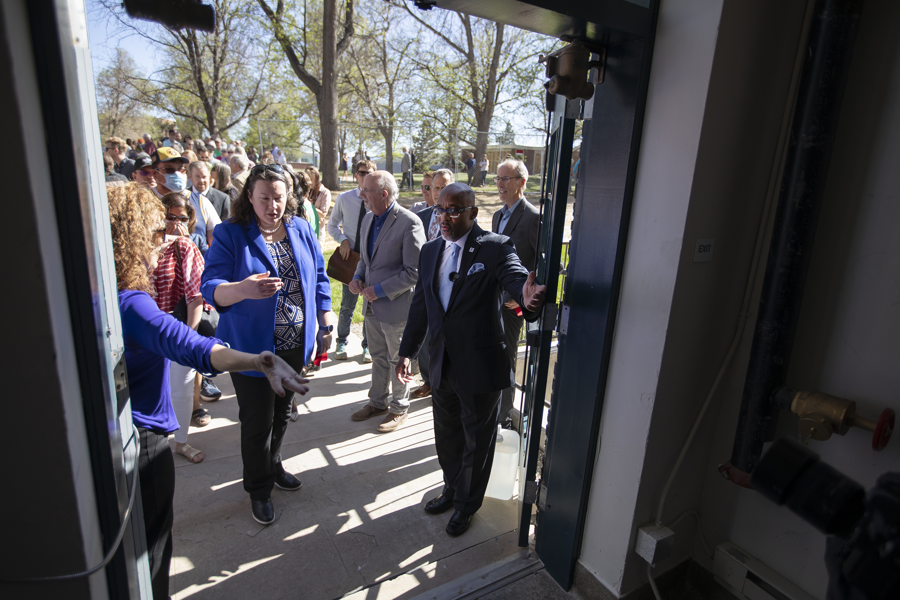 Denver Mayor Michael Hancock, right, waves people into the entrance to view apartments during the grand opening of 74 affordable housing units at the newly restored Pancratia Hall on Thursday, May 12, 2022, in Denver, Colo. (Timothy Hurst/The Denver Gazette) (Timothy Hurst)