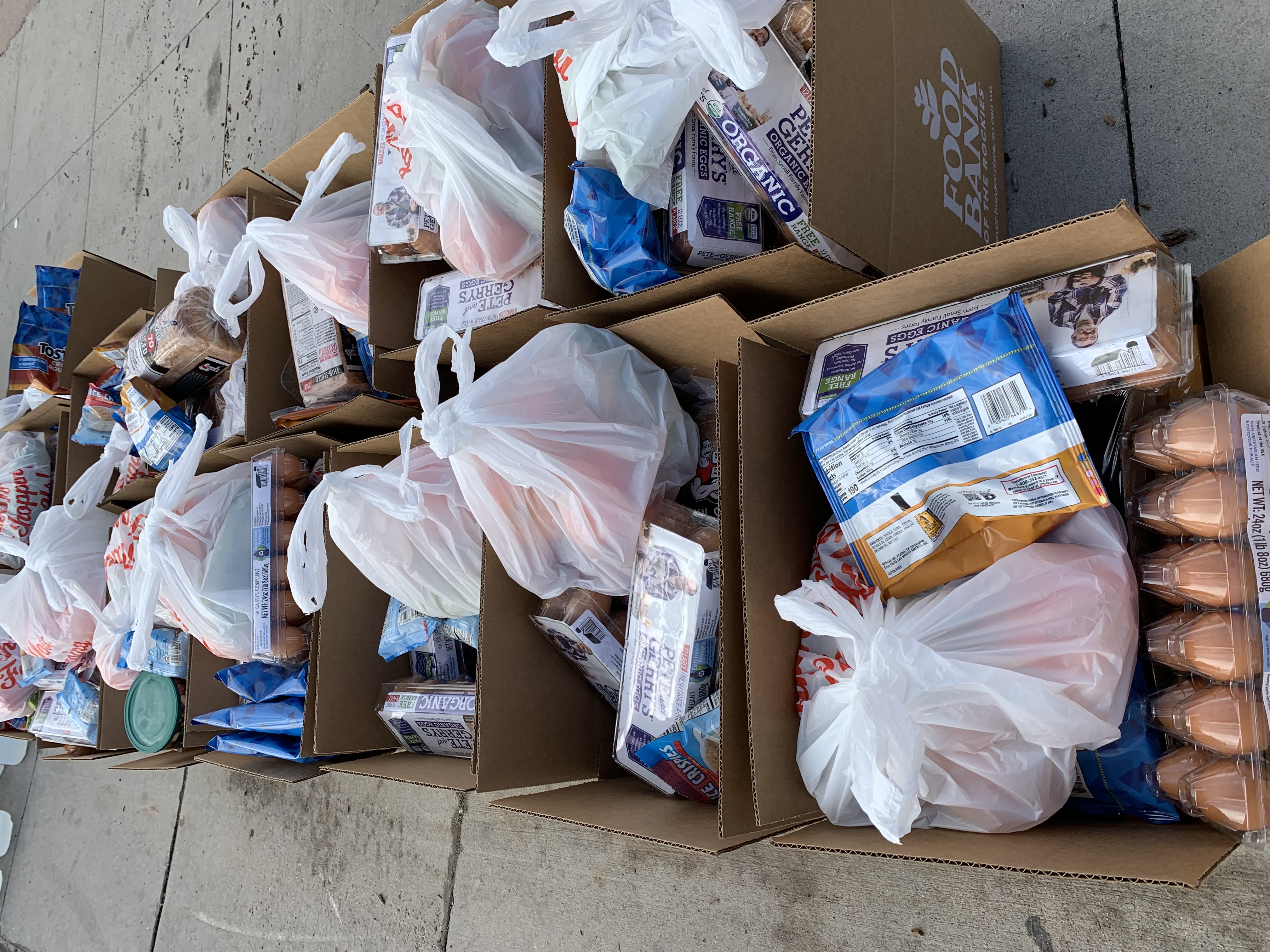 Boxes of food waiting to be distributed at the Food Bank of the Rockies mobile food pantry at Montbello Recreation Center in Aurora Thursday. (DENNIS HUSPENI/THE DENVER GAZETTE)