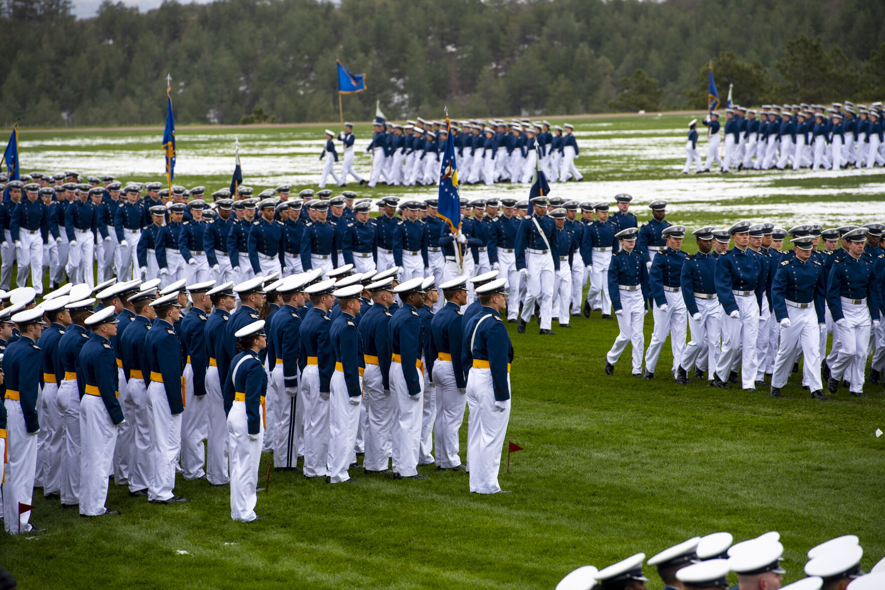 Graduating Air Force Academy cadets watch as their squadrons march past them during Air Force Academy graduation parade at Stillman Parade Field on Tuesday, May 24. The Academy is graduating almost 1,000 cadets on Wednesday, May 25. (Parker Seibold / The Gazette) (Parker Seibold / The Gazette)