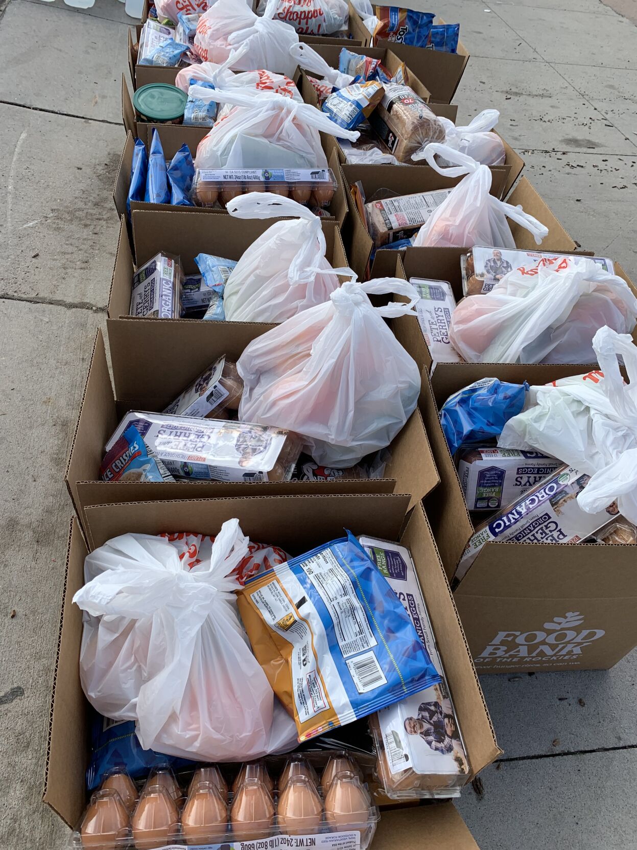 Boxes of food waiting to be distributed at the Food Bank of the Rockies mobile food pantry at Montbello Recreation Center in Aurora Thursday. (DENNIS HUSPENI/THE DENVER GAZETTE)