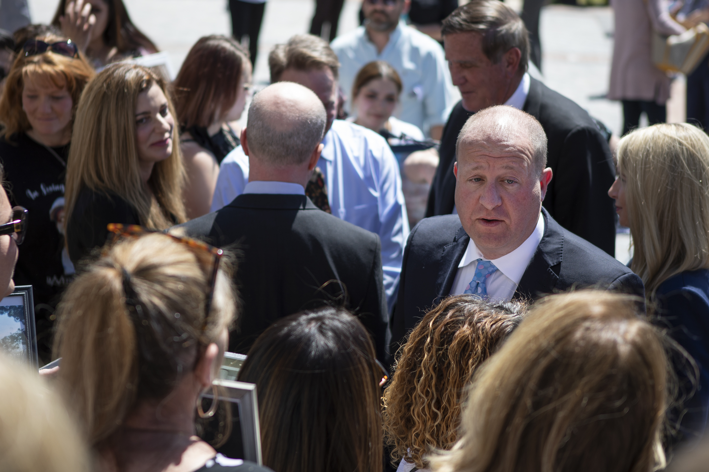 Gov. Jared Polis thanks families that lost loved ones after signing the HB22-1326 Fentanyl Accountability And Prevention bill on Wednesday, May 25, 2022, on the west steps of the Colorado State Capitol Building in Denver, Colo. (Timothy Hurst/The Denver Gazette) (Timothy Hurst)