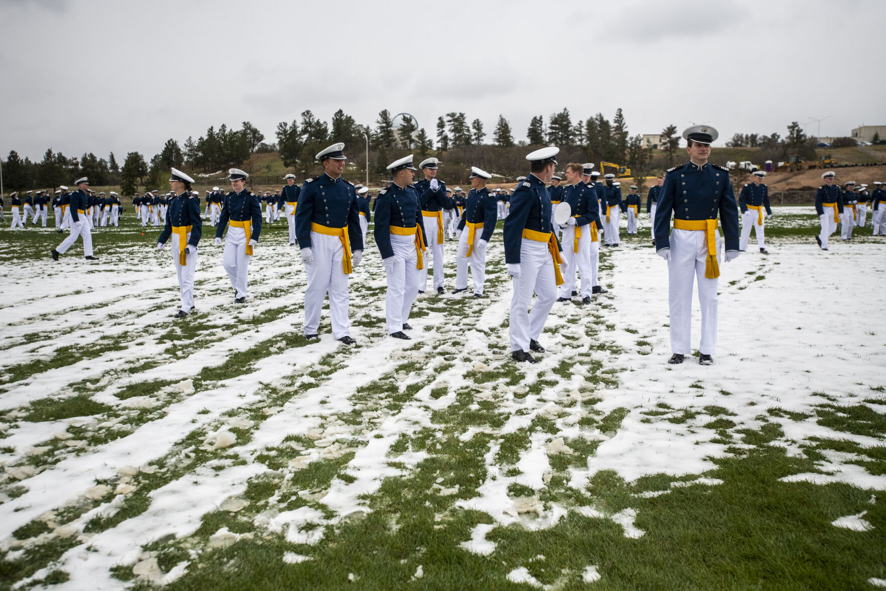 Cadets wait for their family and friends to joint them on the field after the Air Force Academy graduation parade at Stillman Parade Field on Tuesday, May 24. (Parker Seibold / The Gazette) (Parker Seibold / The Gazette)