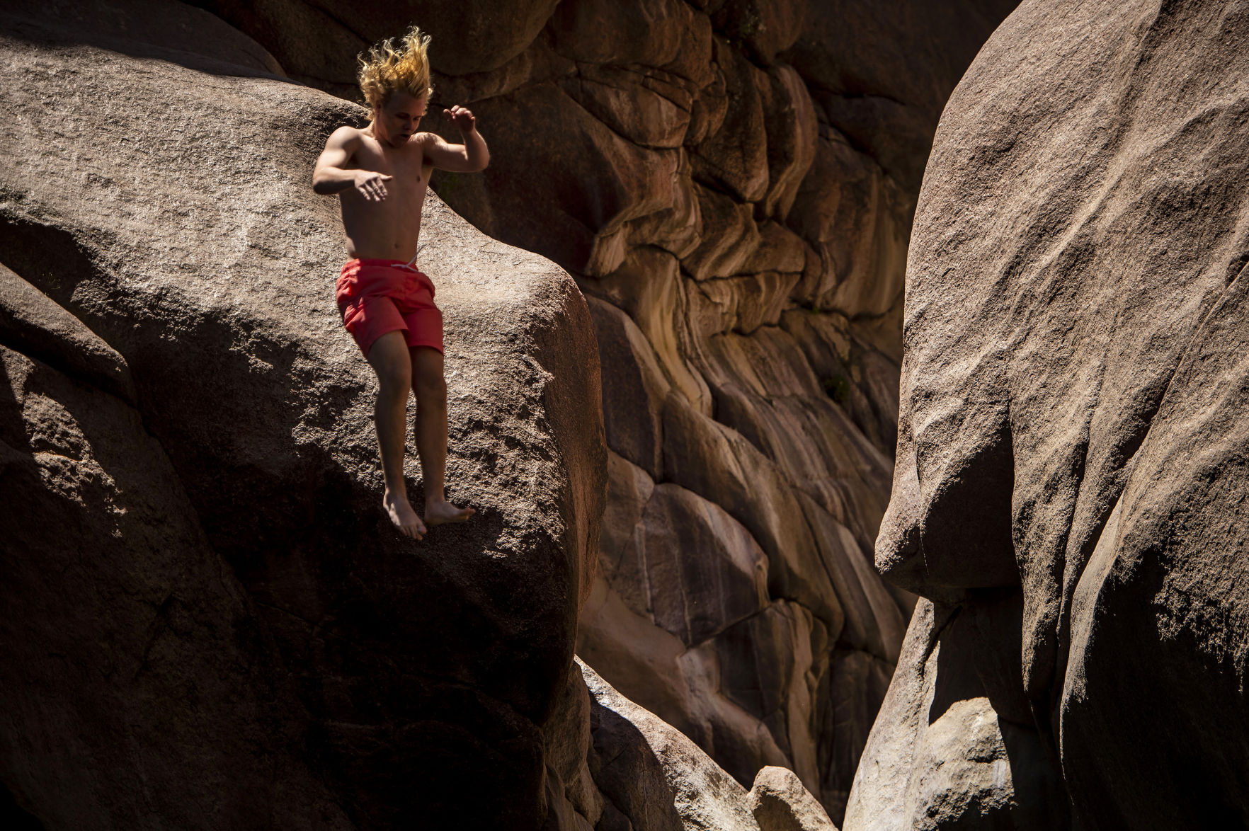 Connor Eise, 17, leaps into Paradise Cove outside of Guffey in Park County in July 2019. (Chancey Bush, The Gazette)