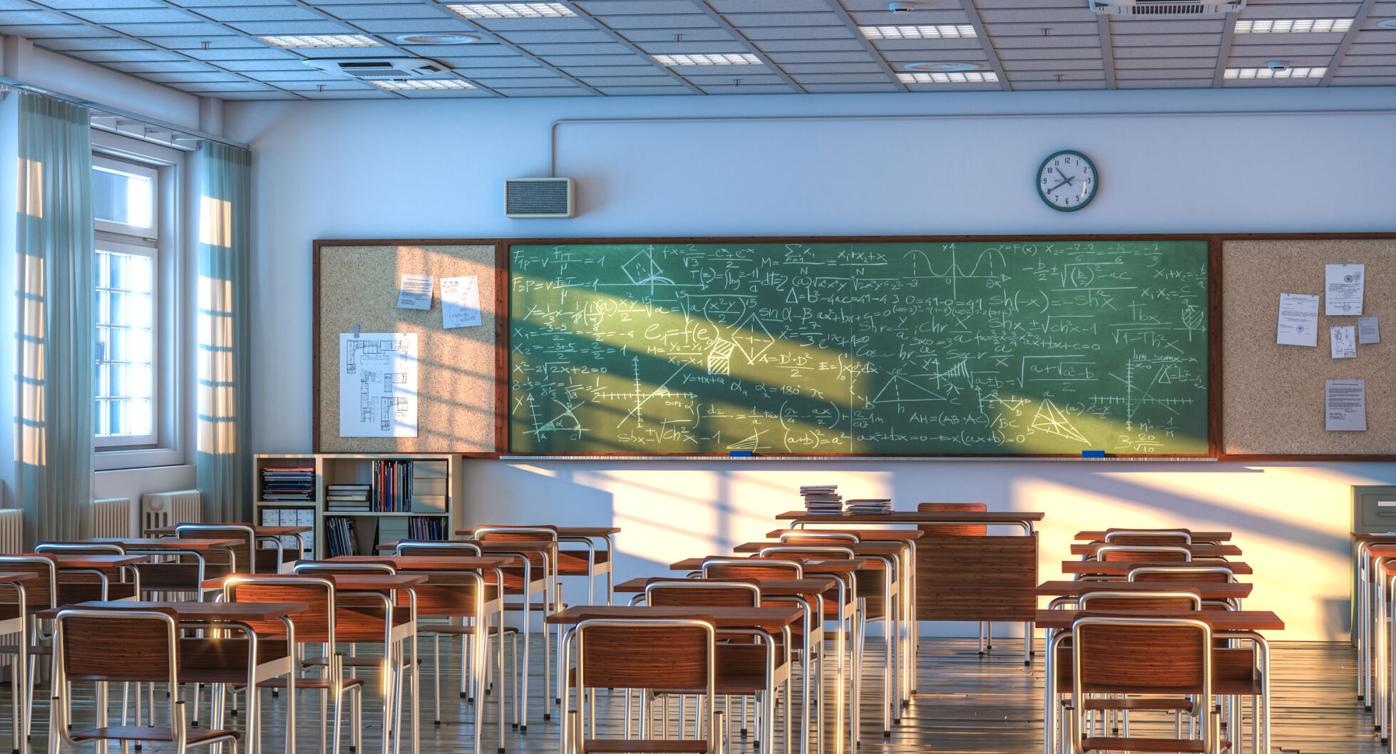 interior of a school classroom with wooden desks and chairs. (copy) (copy)