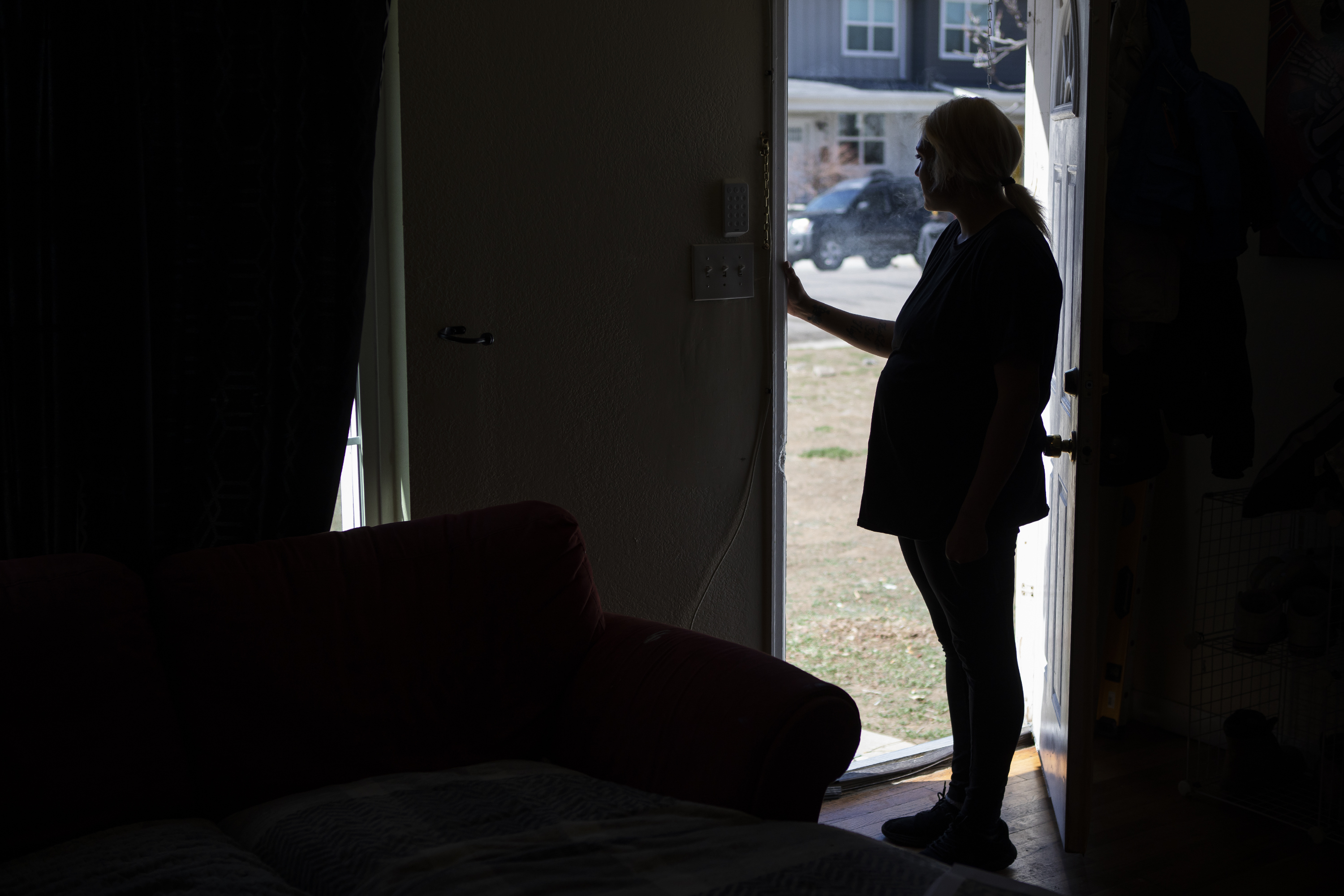 Brandee Lee Eighmy, the older sister of Bradyn Heit, smokes a cigarette at her doorway while talking about her brother’s overdose death on Monday, April 4, 2022, at her home in Aurora, Colo. (Timothy Hurst/The Denver Gazette) (Timothy Hurst)