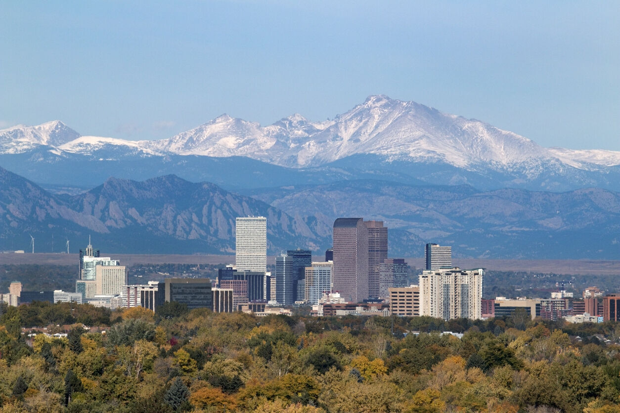 Snowy Longs Peak and Downtown Denver Colorado skyscrapers Photo Credit: milehightraveler (iStock). (copy)