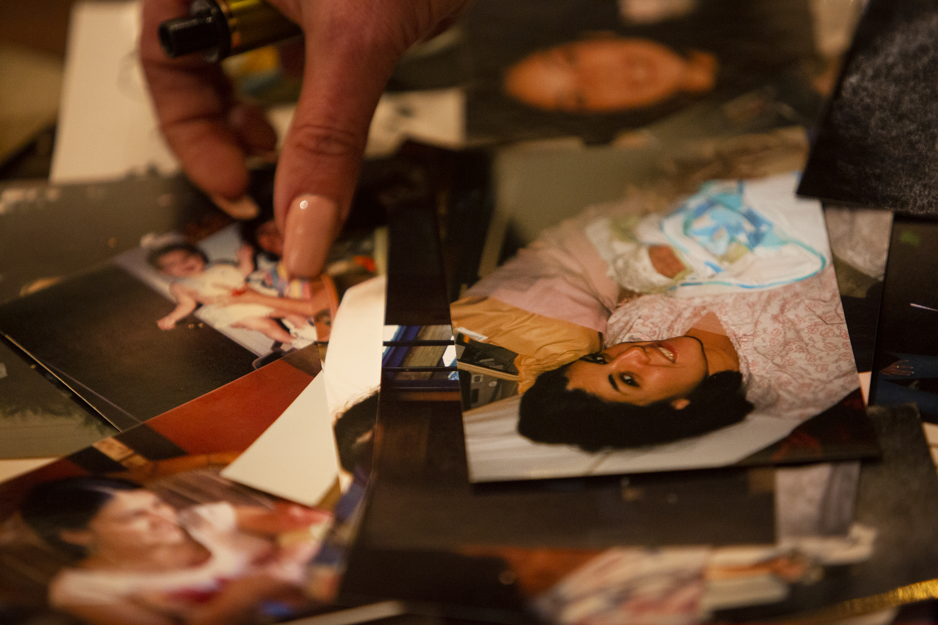 Andrea Thomas thumbs through photos of her late daughter Ashley Romero, who died from fentanyl in 2018, on Tuesday, April 19, 2022, in her home in Mesa County, Colo. (Timothy Hurst/The Denver Gazette) (Timothy Hurst)