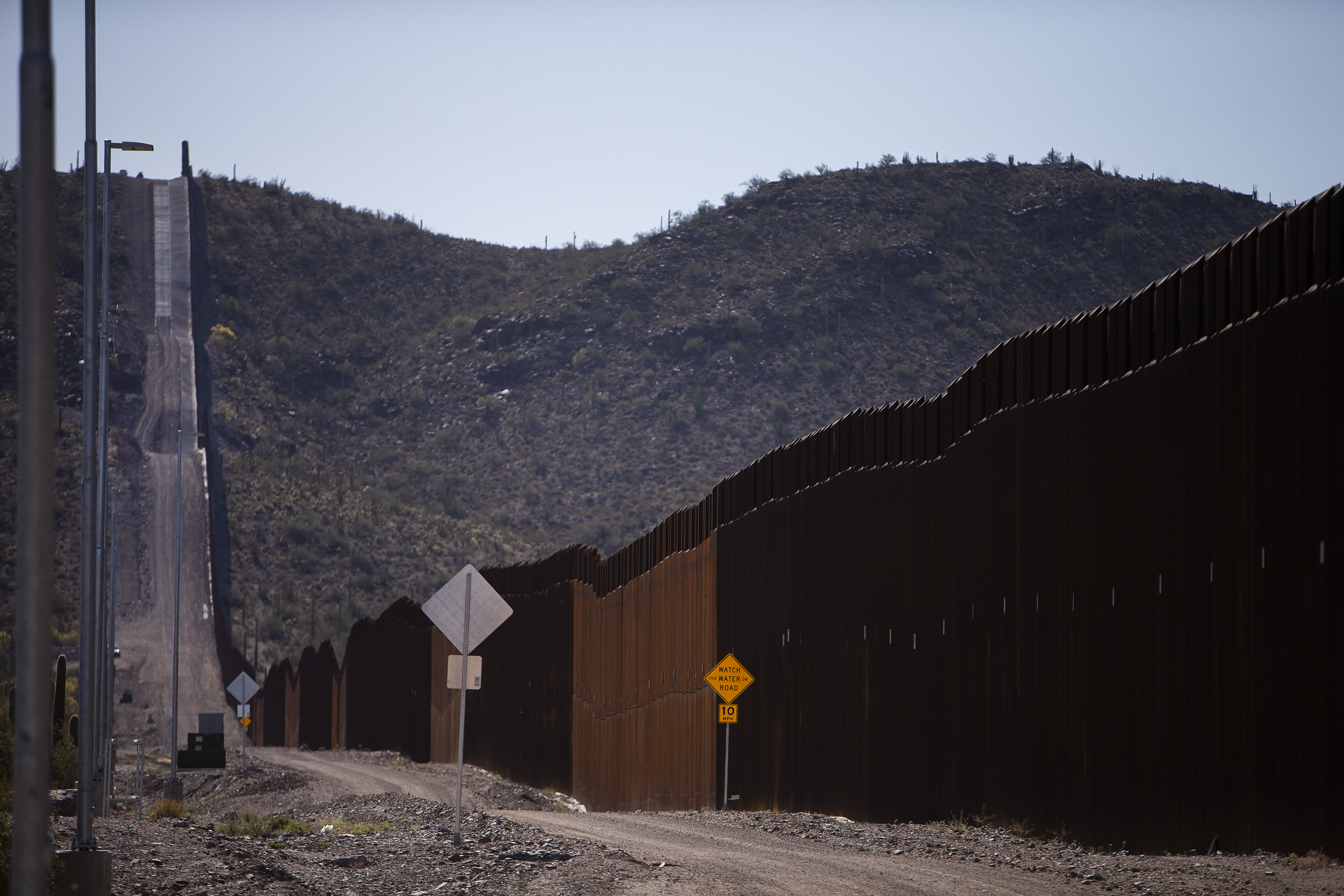 The U.S.-Mexico border wall stretches up and over a hill claimed to be a burial site for the Tohono O'Odham Nation on Thursday, April 21, 2022, near Lukeville, Ariz. (Timothy Hurst/The Denver Gazette) (Timothy Hurst)