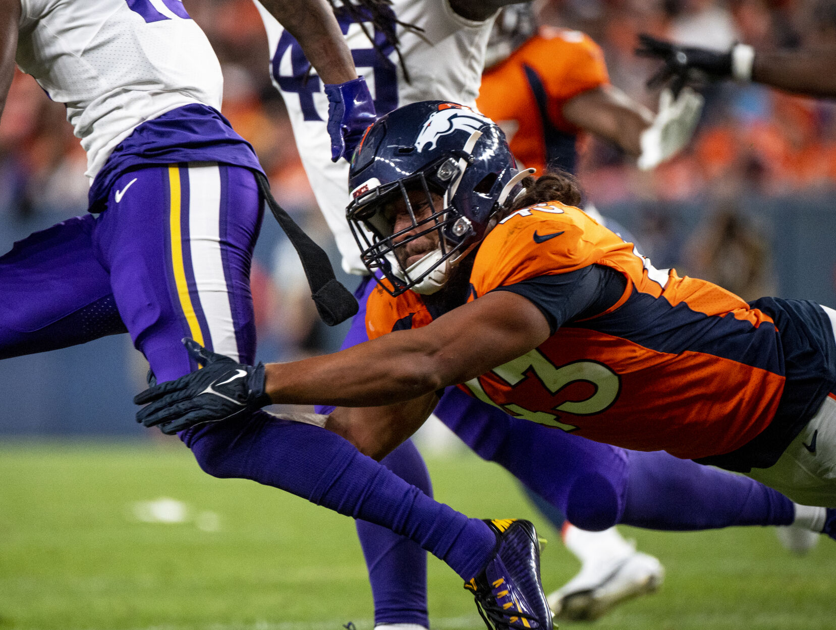 Denver Broncos linebacker Kana'i Mauga (43) grabs Minnesota Vikings wide receiver Ihmir Smith-Marsette (15) by the leg during the third and final preseason game of the year at Empower Field at Mile High in Denver on Saturday, Aug. 27, 2022. (Parker Seibold / The Gazette) (Parker Seibold / The Gazette)