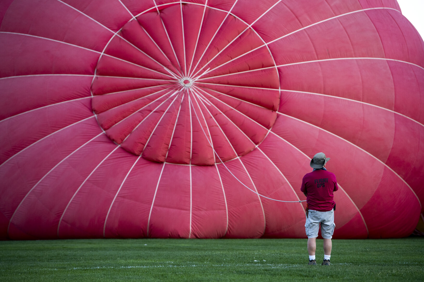 A crew member helps hold an inflating balloon in Memorial Park on Friday, Sept. 2, 2022. (Parker Seibold / The Gazette) (Parker Seibold/ The Gazette)