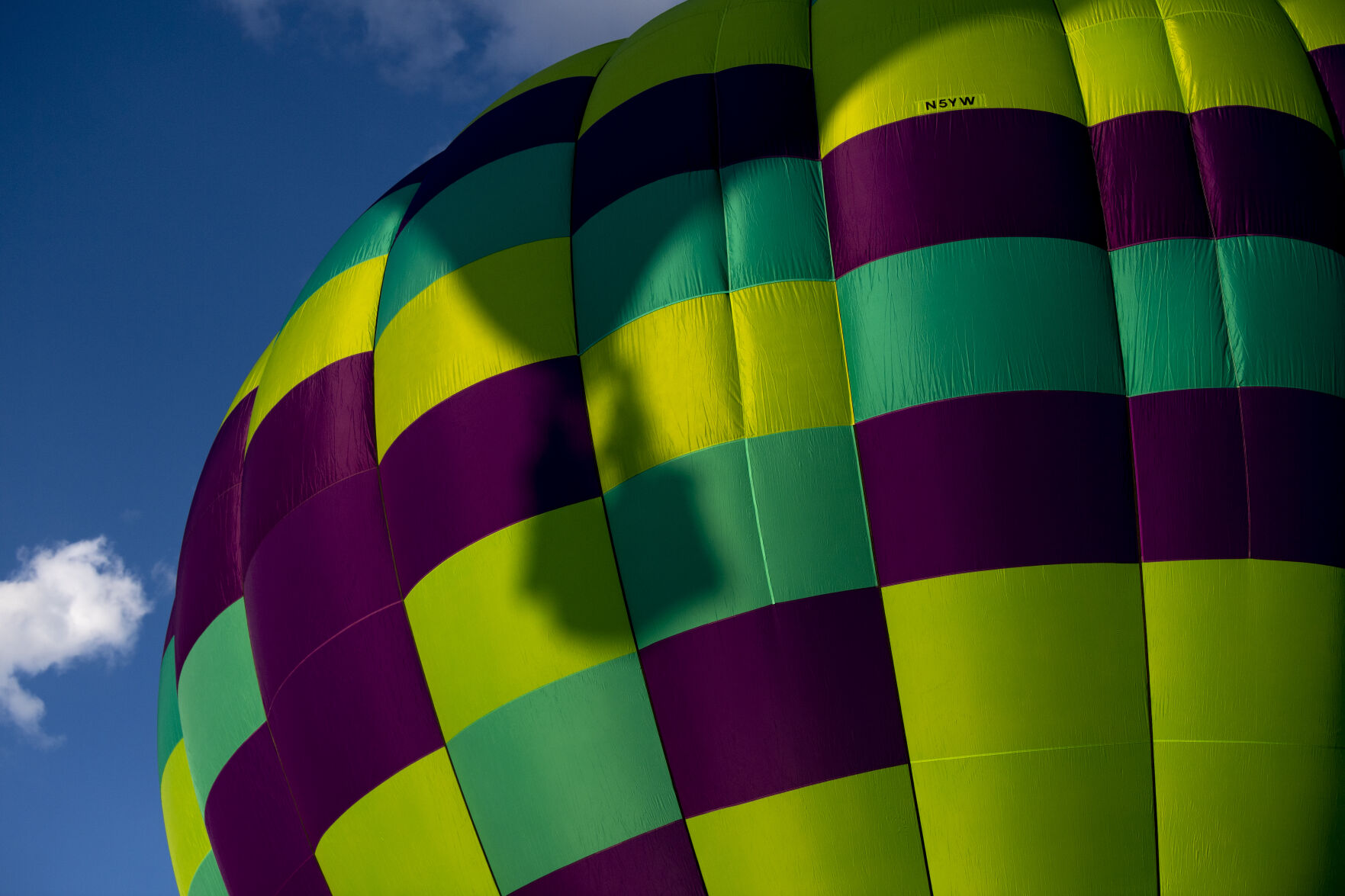 A hot air balloon casts a shadow on another balloon as it takes flight from Memorial Park on Friday, Sept. 2, 2022. (The Gazette, Parker Seibold) (The Gazetter Parker Seibold)