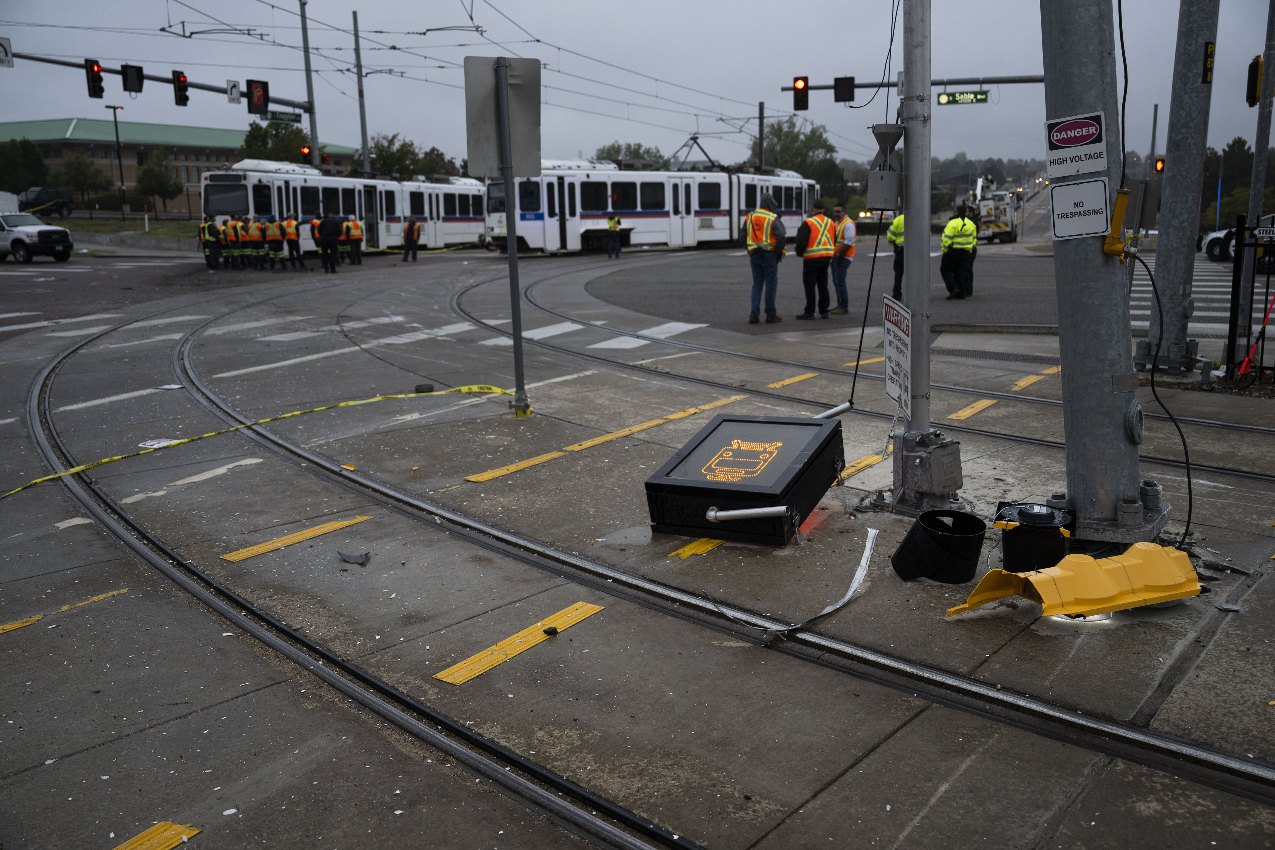 A damaged train crossing signal sits on the rails as crews work the scene where a RTD light-rail train derailed at the intersection of East Exposition Avenue and South Sable Boulevard on Wednesday, Sept. 21, in Aurora, Colo.(TIMOTHY HURST/THE DENVER GAZETTE) (TimHursttim.hurst@gazette.comhttps://secure.gravatar.com/avatar/aca82bd62b4ee425c598527cd6faa1b1?d=mm&r=g)