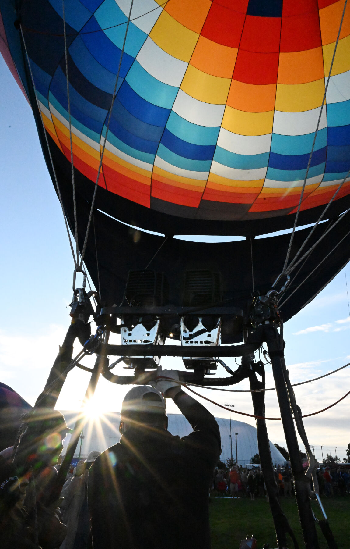 The sun comes up as balloon pilot David Hettich gets ready to take off as the sun comes up on Saturday, Sept. 3, 2022. Hettich has a balloon in the liftoff called The Long Run. . (Photo by Jerilee Bennett, The Gazette) (Jerilee Bennett)