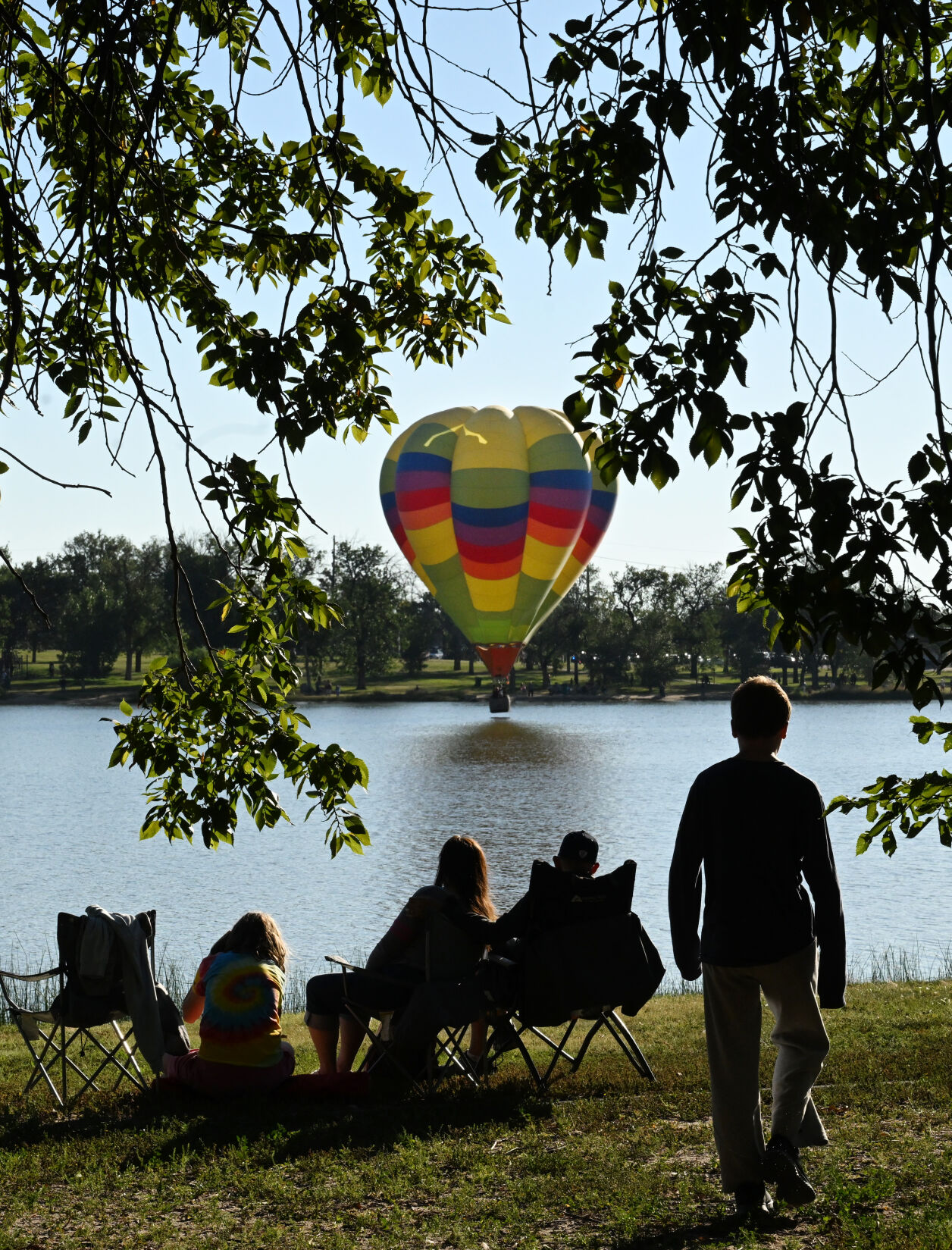 People watch as a balloon dips in Prospect Lake during the Labor Day Lift Off. (Photo by Jerilee Bennett, The Gazette) (Jerilee Bennett)