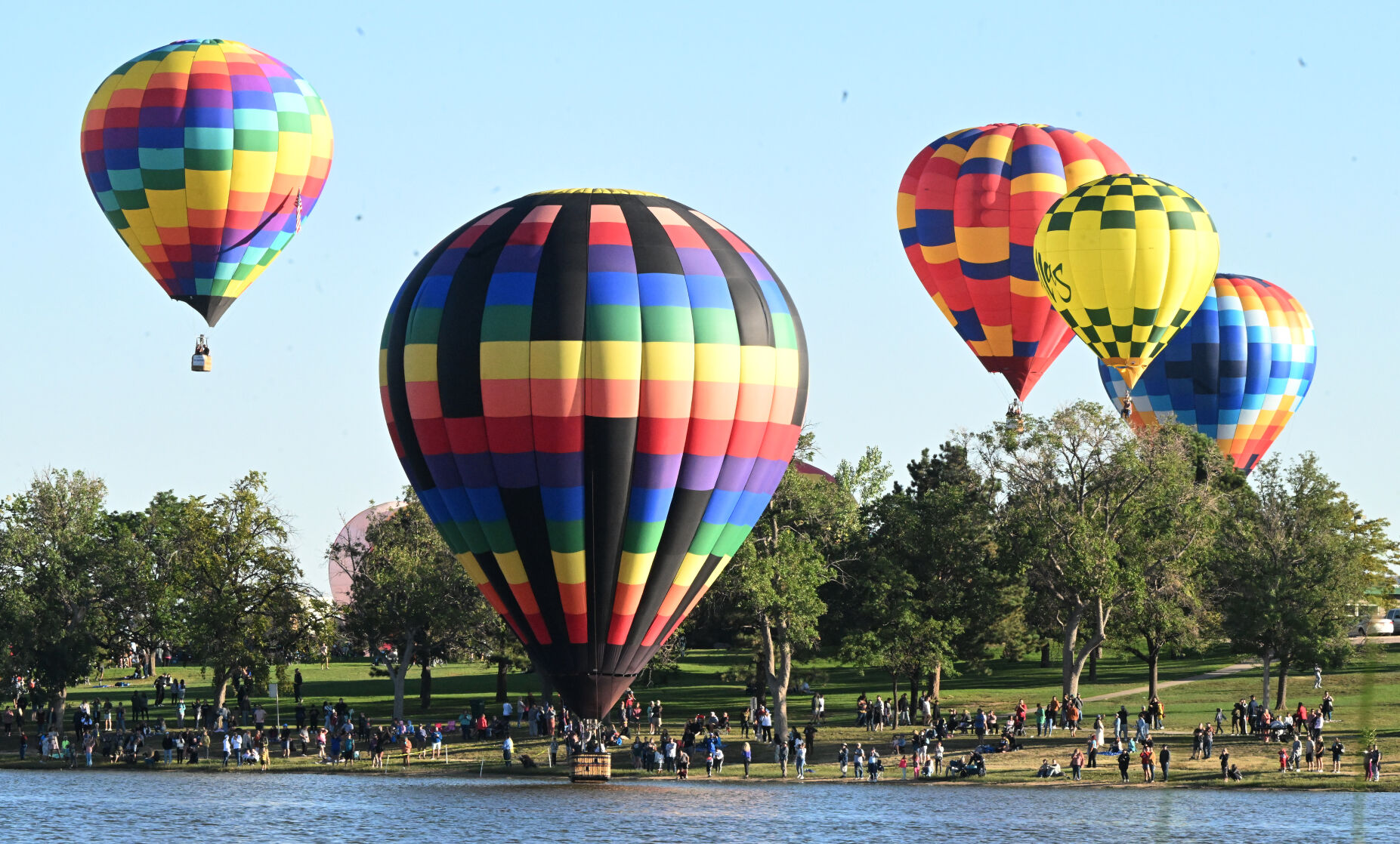 Balloons head for Prospect Lake to take a dip on the second day of the Labor Day Liftoff on Sunday, Sept. 4, 2022. (Photo by Jerilee Bennett, The Gazette) (Jerilee Bennett)
