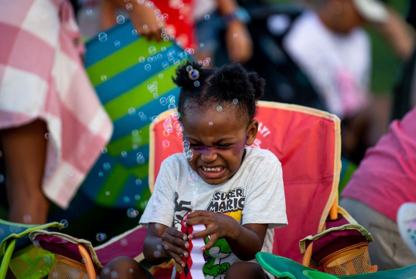 Zachary King excitedly blows bubbles with a toy he got at Labor Day Lift Off at Memorial Park on Saturday, Sept. 3, 2022. (The Gazette, Parker Seibold) (Parker Seibold/ The Gazette)