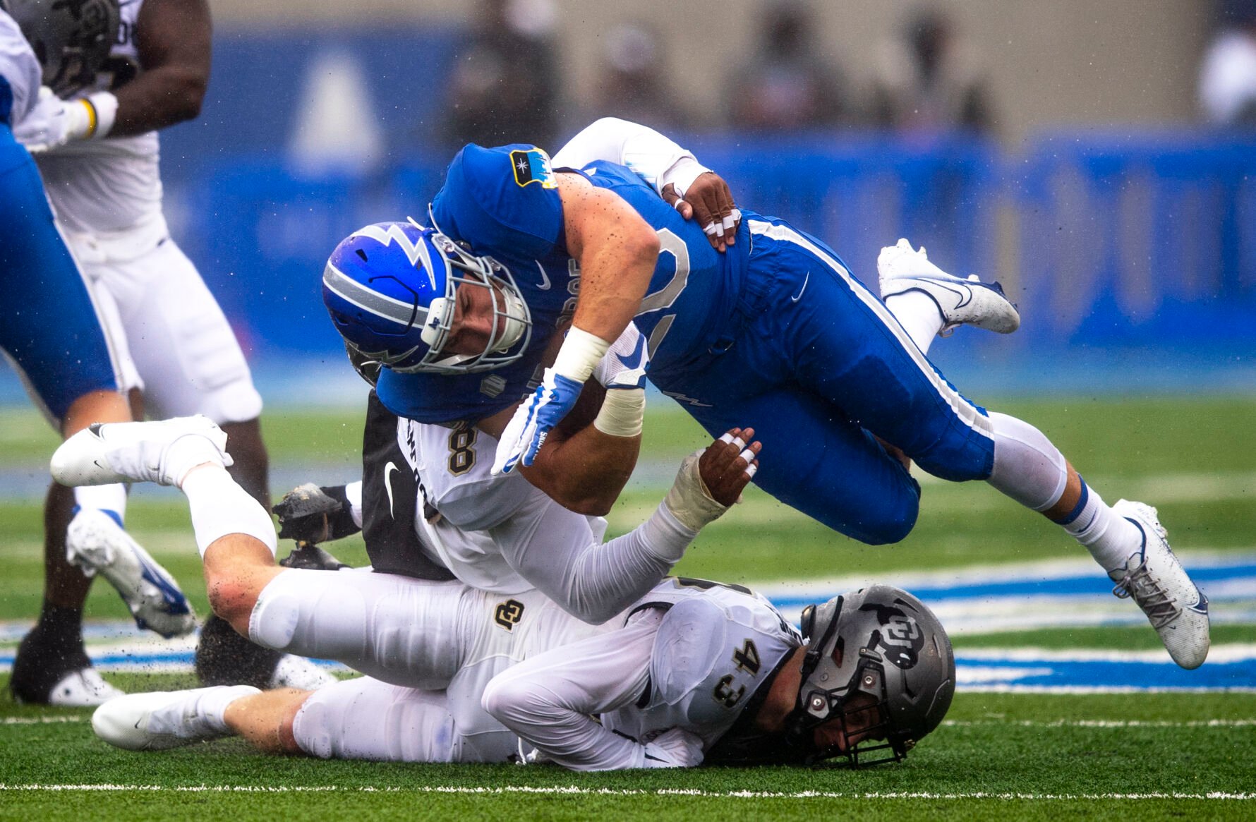 Falcons running back Brad Roberts is tackled by Colorado safety Trevor Woods (43) and linebacker Josh Chandler-Semedo (8) during a Sept. 10 game at Falcon Stadium in Colorado Springs. (Parker Seibold, The Gazette)