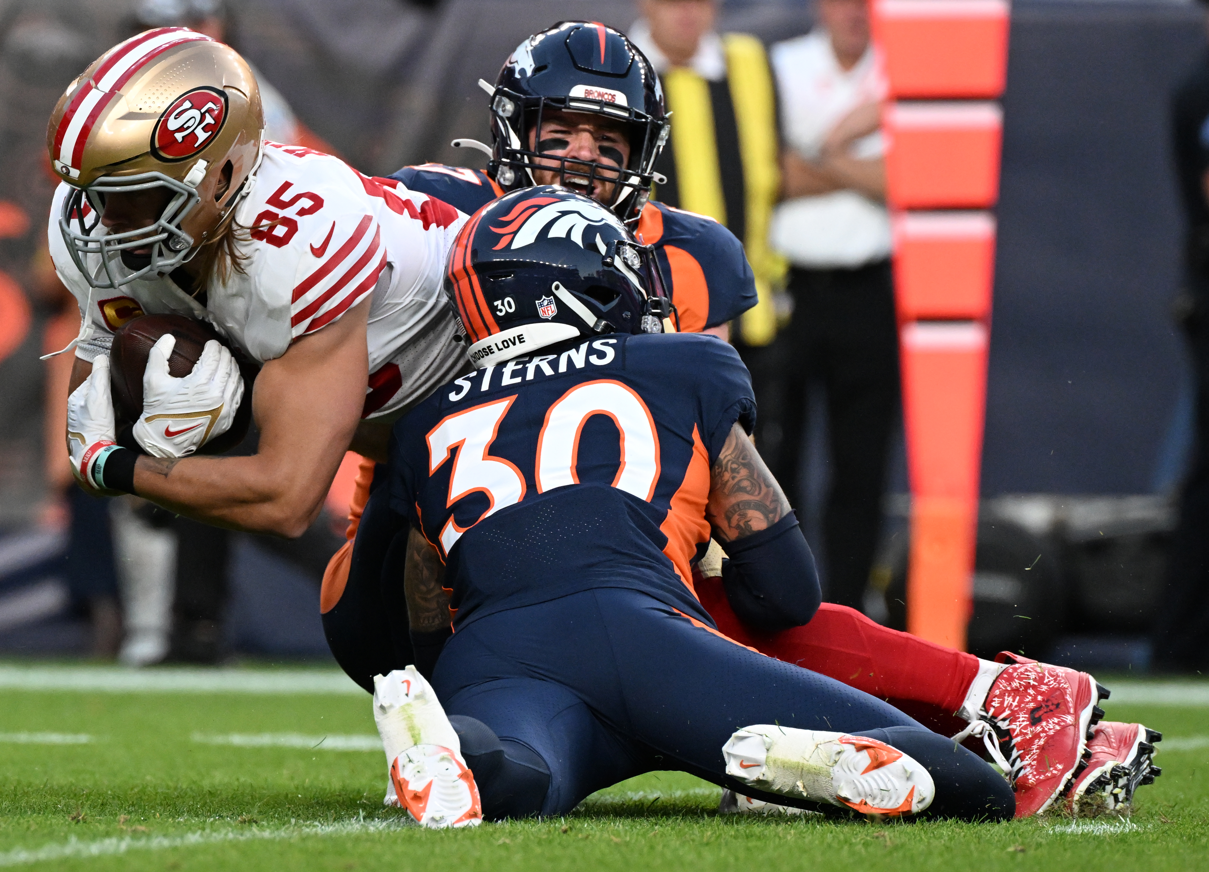 Denver Broncos linebacker Josey Jewell (47) and safety Caden Sterns (30) stop San Francisco 49ers tight end George Kittle (85) after a short gain during the first quarter Sunday, Sept. 25, 2022, at Empower Field at Mile High in Denver. (The Gazette, Christian Murdock) (Christian Murdock/The Gazette)