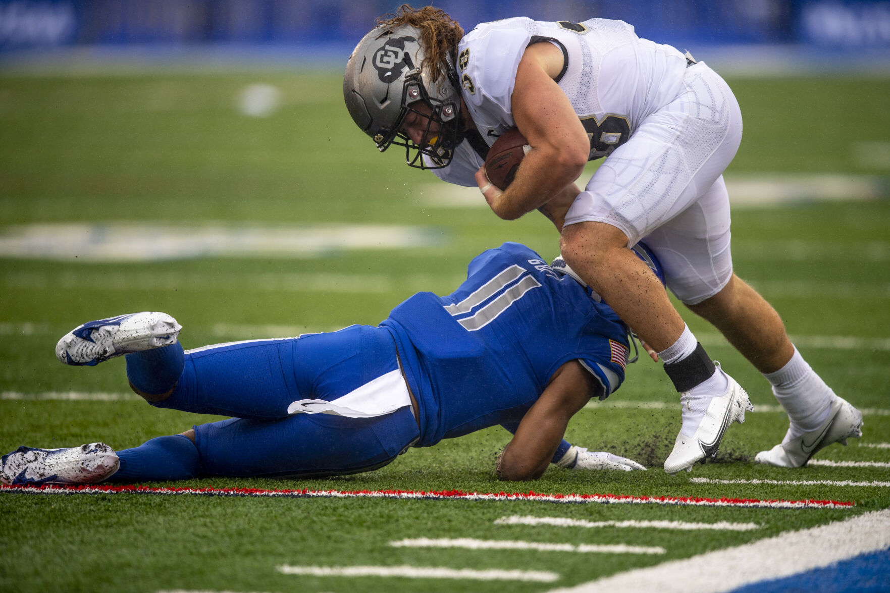 Colorado Buffaloes tight end Brady Russell (38) is pushed out of bounds by Air Force Falcons safety Camby Goff (11) during the third quarter of the game at Falcon Stadium in Colorado Springs, Colo., on Saturday, Sept. 10, 2022. The Falcons won 41-10. (The Gazette, Parker Seibold)