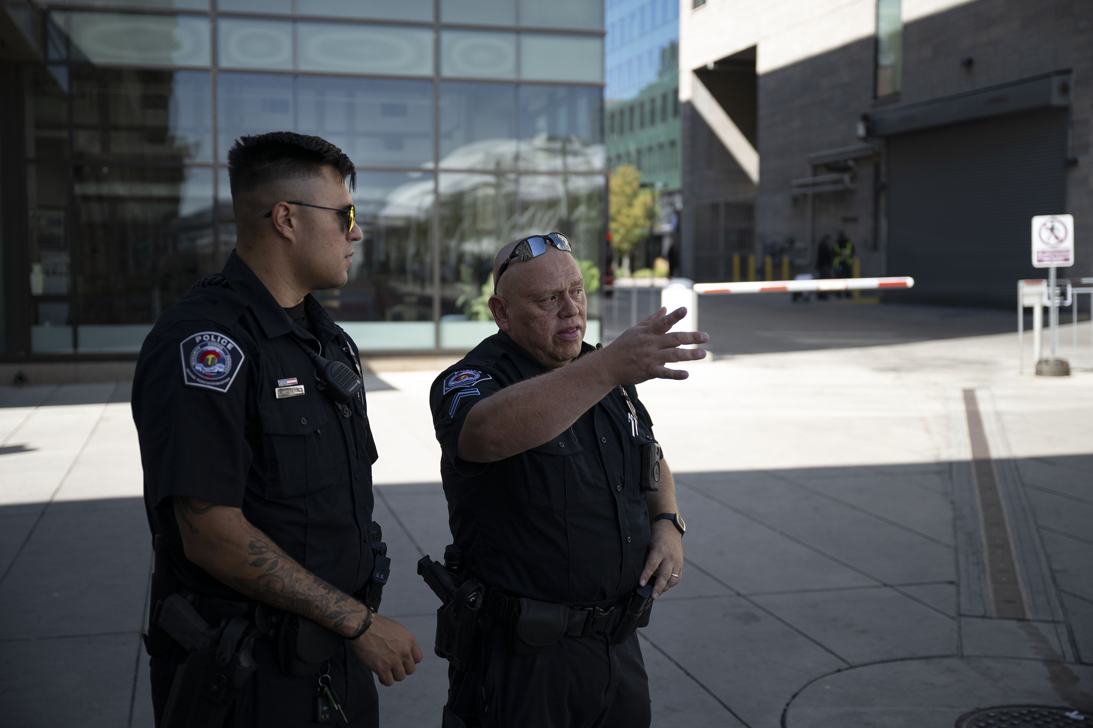 RTD Police Cpl. Conrad Vanegas, right, and officer Chance Fitzgerald discuss their route before walking the outdoor commuter rail concourse on Thursday, Aug. 11, 2022, at Union Station in Denver, Colo. (Timothy Hurst/The Denver Gazette) (Timothy Hurst)