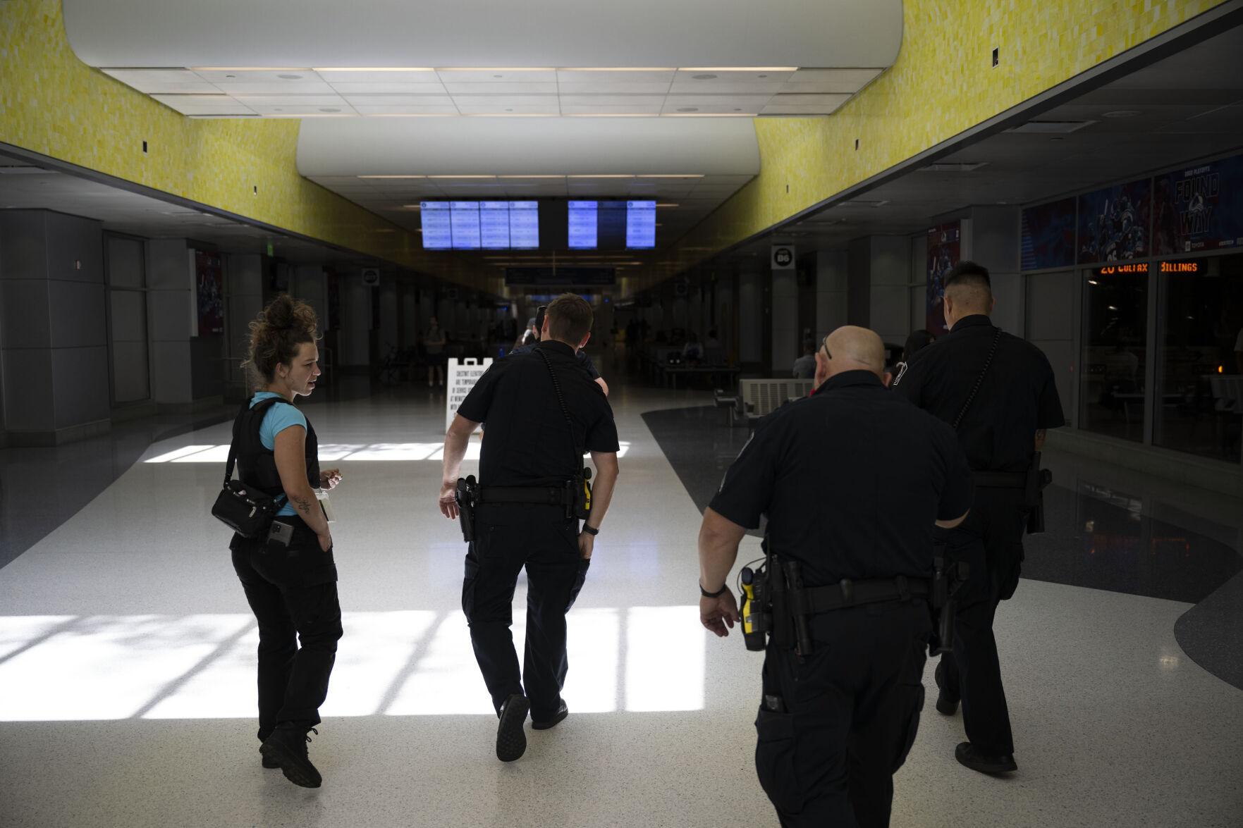 From left, Wellpower co-responder clinician Lara Cladny, RTD Police officer Enrique Nino, Cpl. Conrad Vanegas and Officer Chance Fitzgerald, walk the underground concourse after evicting a woman causing a disturbance at Union Station. (Timothy Hurst, The Denver Gazette)