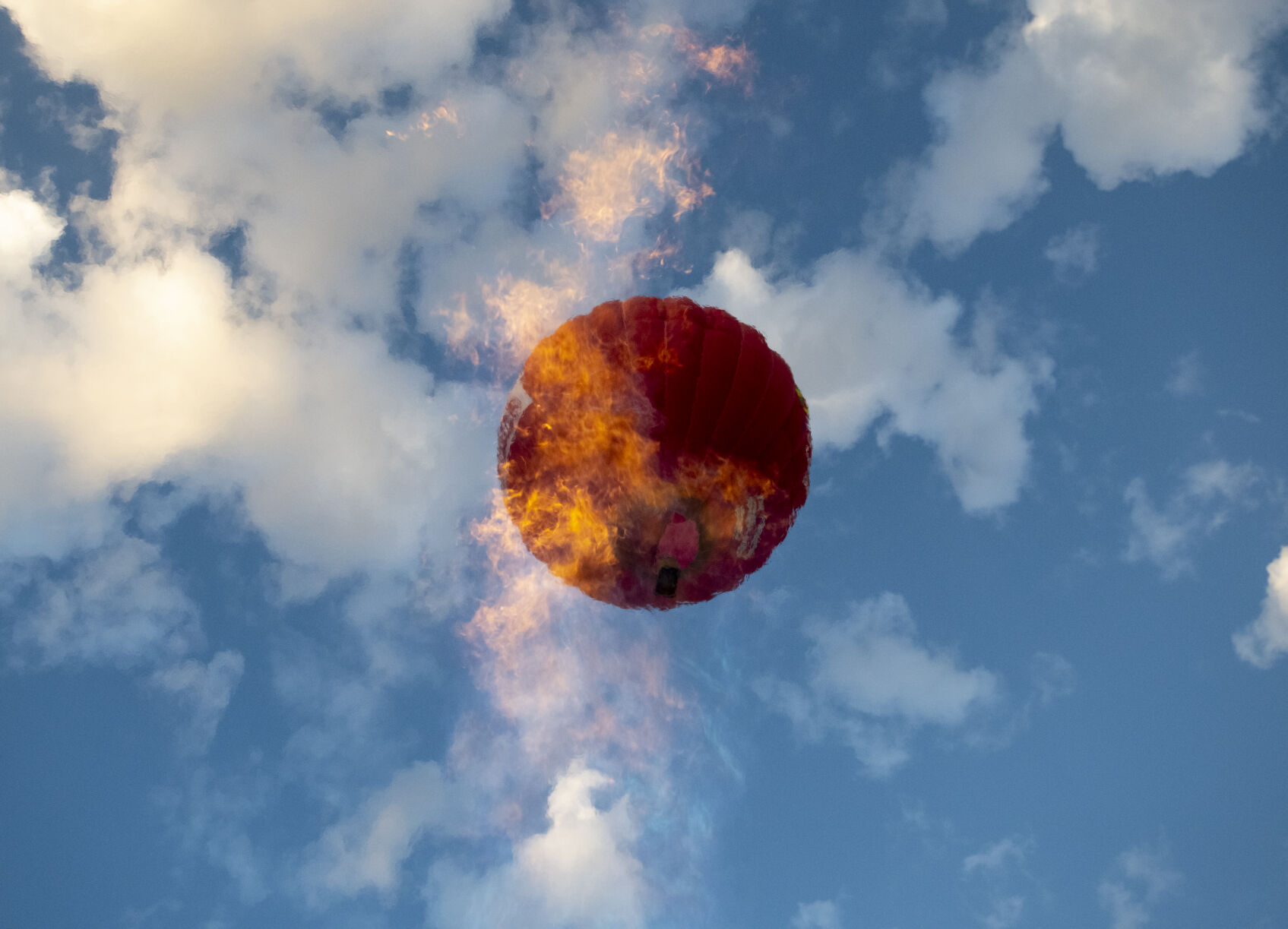 A hot air balloon flies above the flame of a pilot testing their equipment on Friday, Sept. 2, 2022. (The Gazette, Parker Seibold) (The Gazetter Parker Seibold)