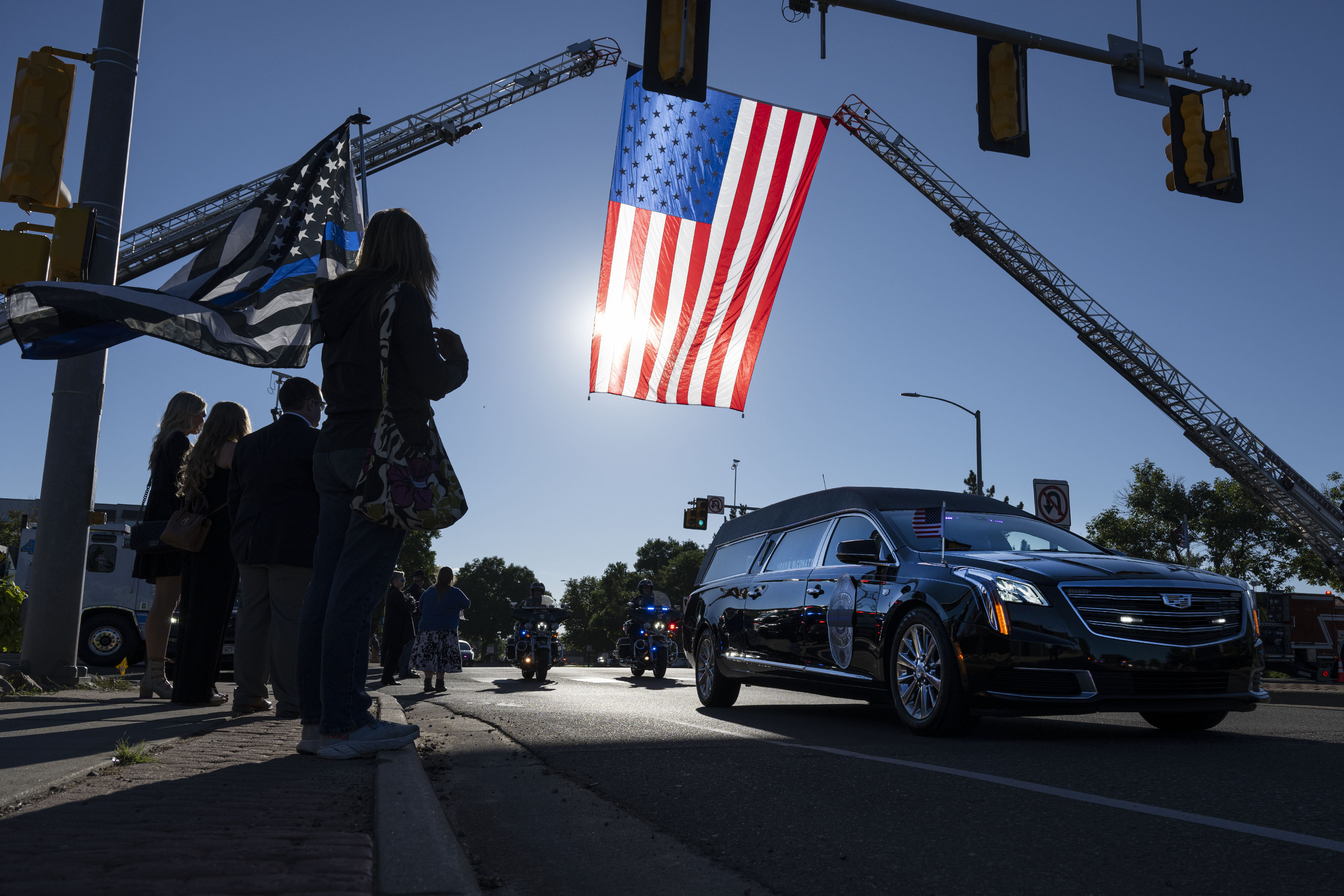 Mourners line the road as the hearse carrying fallen Arvada Police officer Dillon Vakoff drives by on Friday, Sept. 16, 2022, at Flatirons Community Church in Lafayette, Colo. Vakoff was killed in the line of duty last Sunday while responding to a call in Arvada. (Timothy Hurst/The Denver Gazette) (TimHursttim.hurst@gazette.comhttps://secure.gravatar.com/avatar/aca82bd62b4ee425c598527cd6faa1b1?d=mm&r=g)