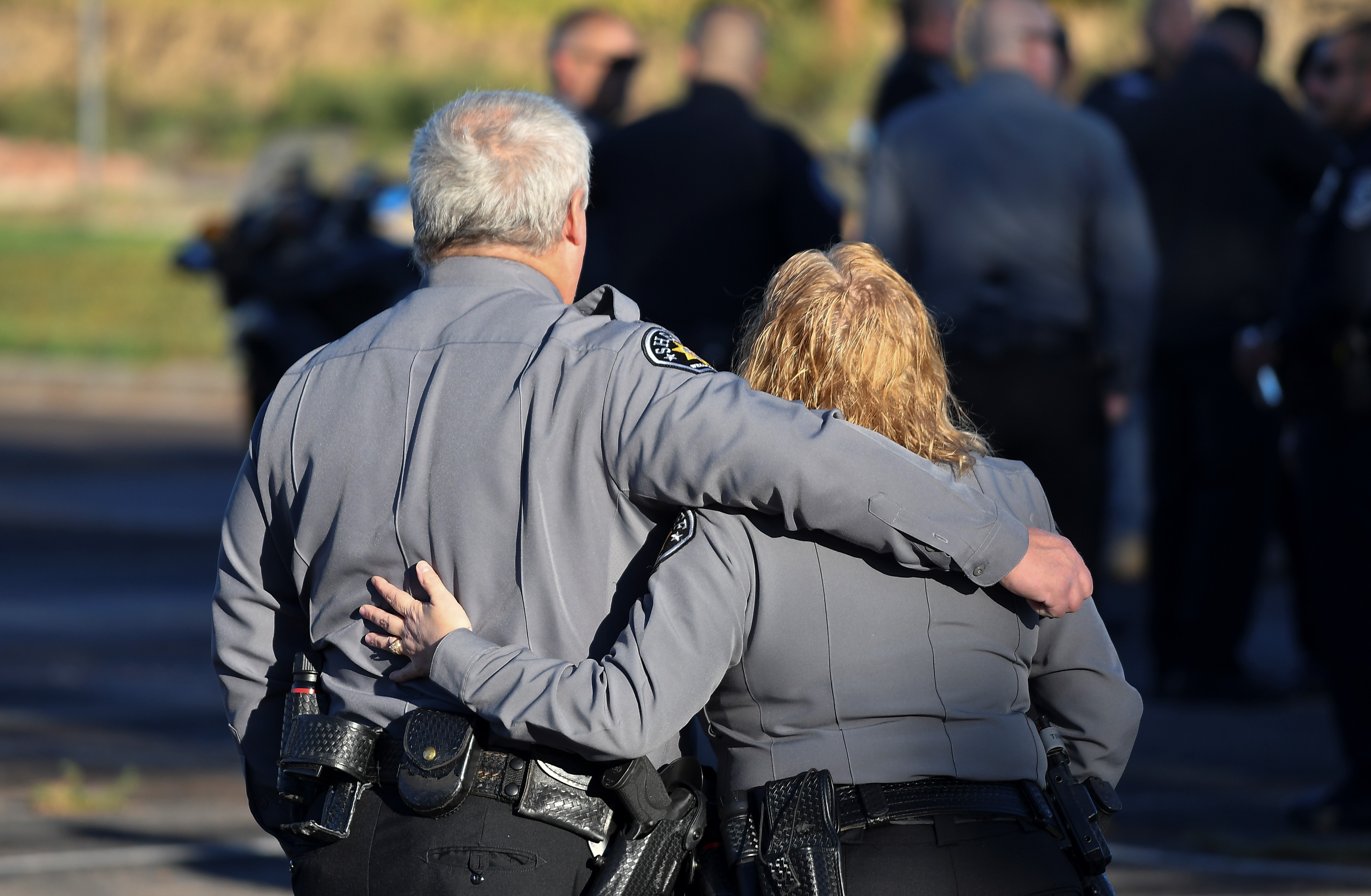 Well County Sheriffs Deputies embrace as they gathered at the Weld County Jail along with a multi-agency enforcement procession for the procession of Weld County Sheriff Deputy Alexis Hein-Nutz to Foundations Church in Loveland. Hein-Nutz was struck and killed by Norberto Garcia-Gonzales at an intersection in Weld County. (John Leyba)