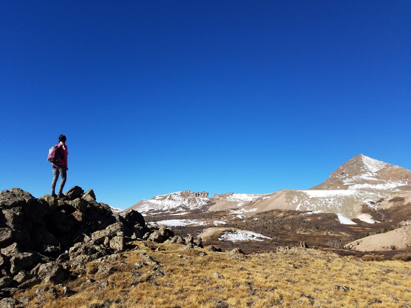 LEFT: A runner looks toward Rio Grande Peak in the San Juan mountains.
