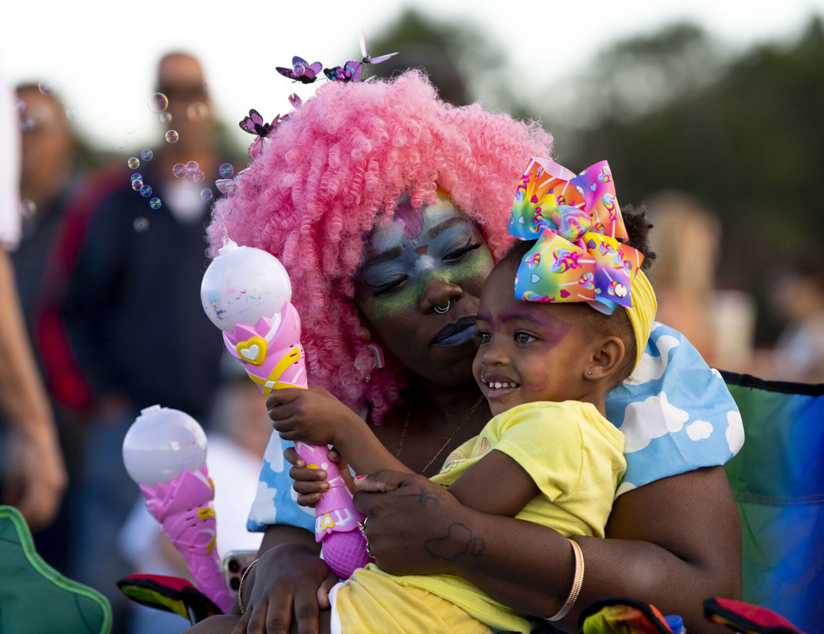 Alexis King hugs her daughter Ezra as they listen to a live band during Labor Day Lift Off at Memorial Park on Saturday, Sept. 3, 2022. (The Gazette, Parker Seibold) (Parker Seibold/ The Gazette)
