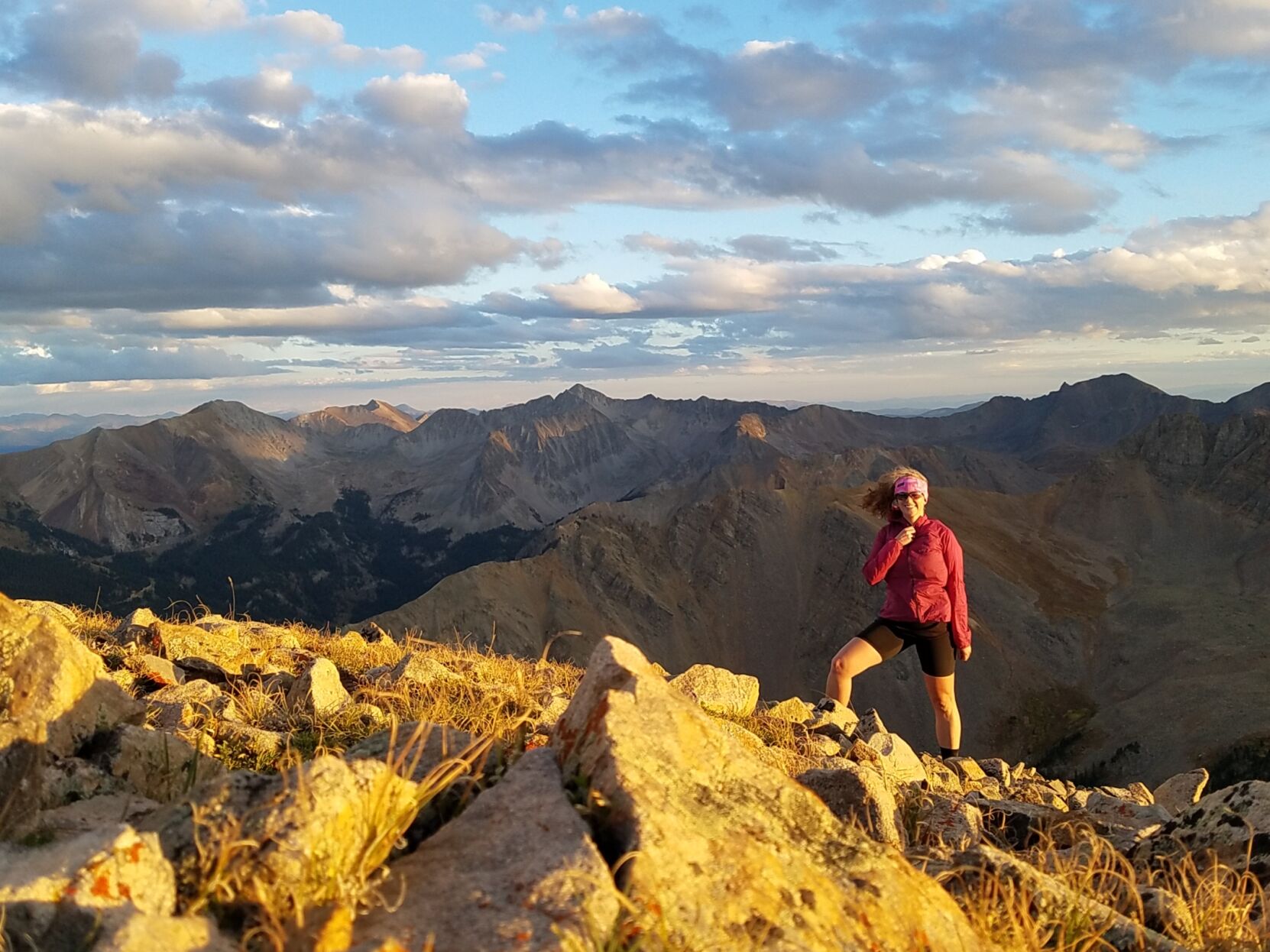 Annalise Grueter smiles atop Leahy Peak in the Elk Range. Grueter has authored a new book on high alpine trail runs in Colorado. (Courtesy photo)