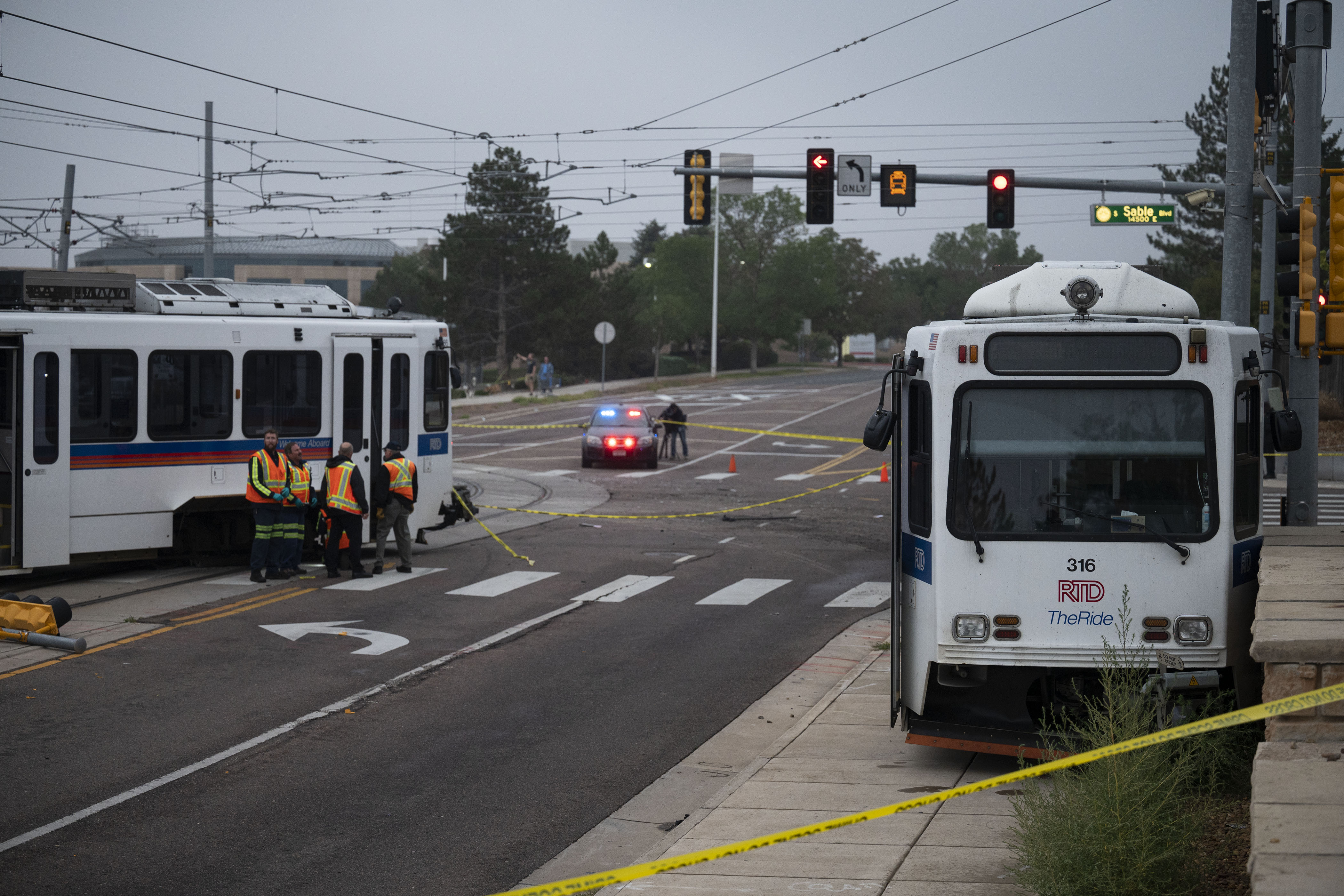 FILE PHOTO: A RTD light-rail train sits on the sidewalk and another section sits derailed on the tracks as crews work the scene at the intersection of East Exposition Avenue and South Sable Boulevard on Wednesday, Sept. 21, in Aurora, Colo. (TimHursttim.hurst@gazette.comhttps://secure.gravatar.com/avatar/aca82bd62b4ee425c598527cd6faa1b1?d=mm&r=g)
