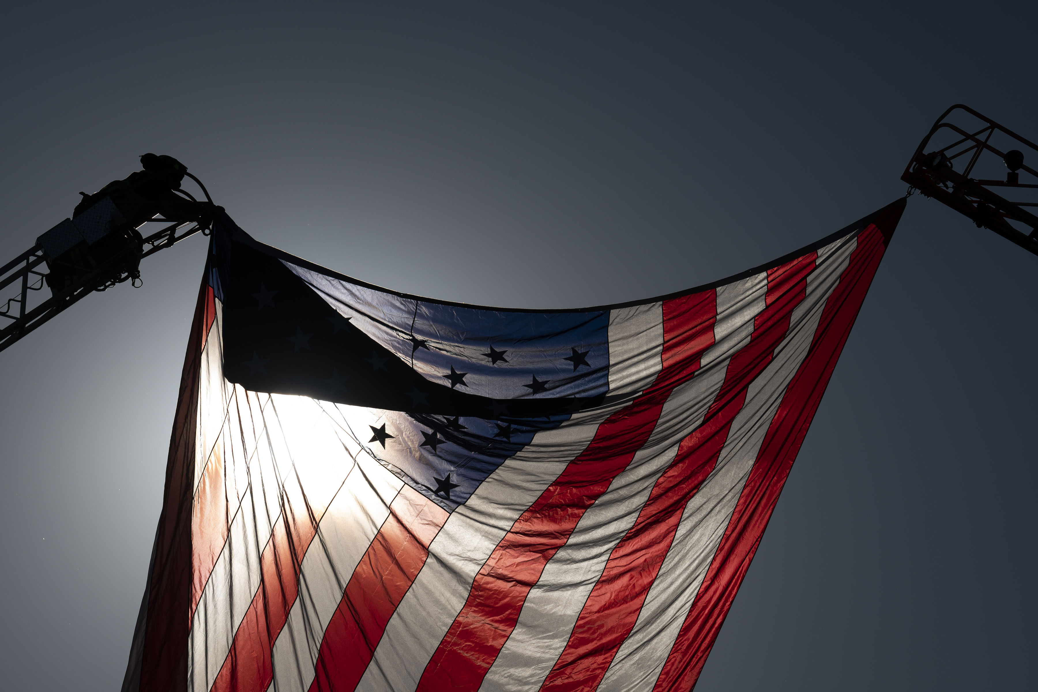 A firefighter unfurls a large American flag over hanging over West South Boulder Road before the funeral procession for fallen Arvada Police officer Dillon Vakoff on Friday, Sept. 16, 2022, at Flatirons Community Church in Lafayette, Colo. Vakoff was killed in the line of duty last Sunday while responding to a call in Arvada. (Timothy Hurst/The Denver Gazette) (TimHursttim.hurst@gazette.comhttps://secure.gravatar.com/avatar/aca82bd62b4ee425c598527cd6faa1b1?d=mm&r=g)
