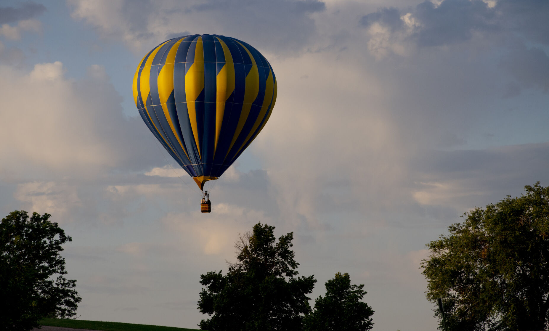 A balloon flies south of Memorial Park during sunrise on Friday, Sept. 2, 2022. Balloons will fill the sky throughout the weekend as the Labor Day Lift Off takes place at Memorial Park over the long holiday weekend. The balloons are scheduled to launch on all three mornings and host glow events on Saturday and Sunday evenings. (The Gazette, Parker Seibold) (The Gazetter Parker Seibold)
