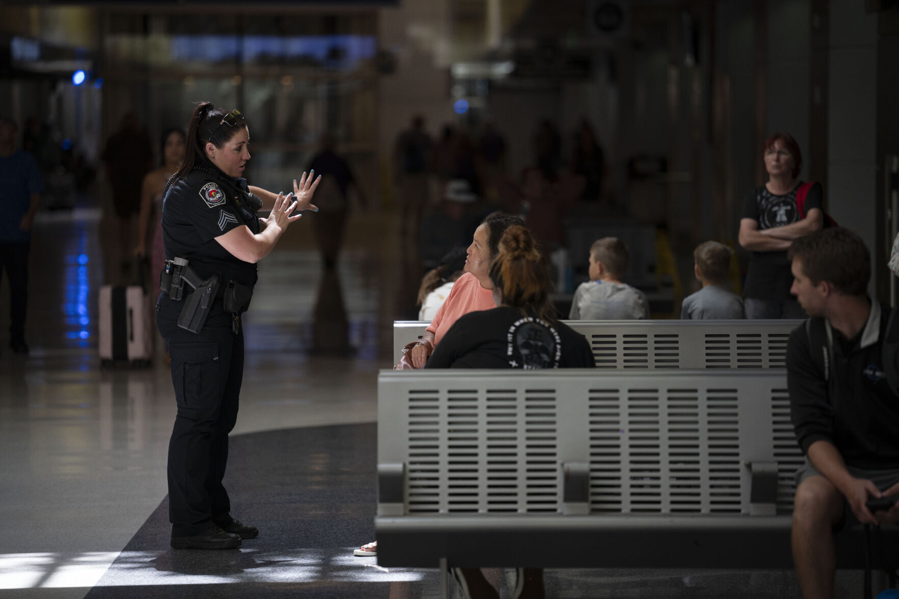 RTD Police Sgt. Jessica Chaine answers a question from commuters in the underground bus concourse at Union Station. (Timothy Hurst, The Denver Gazette)