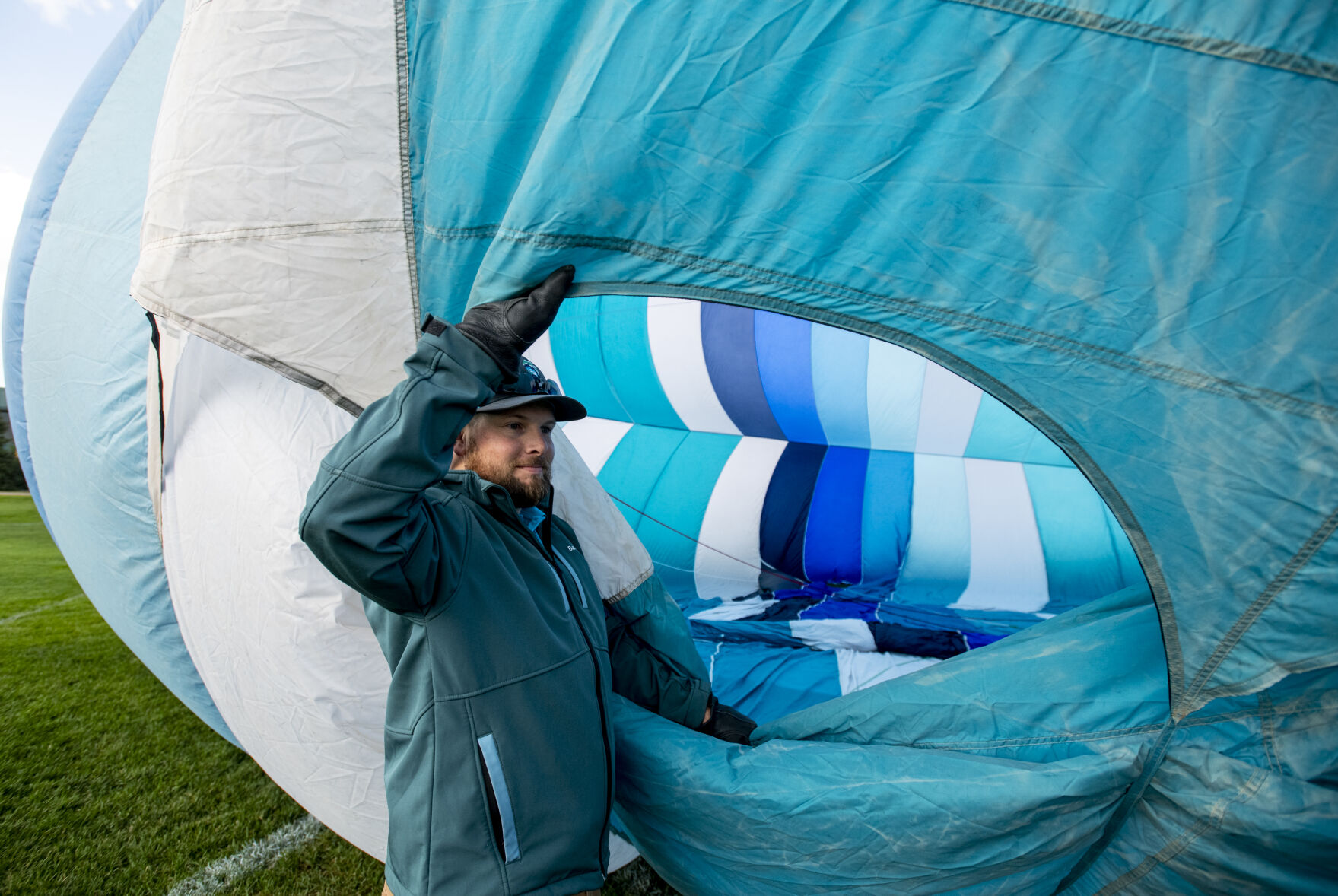 Hot air balloon pilot John Wilson from Albuquerque, N.M.m holds open a vent in his balloon as its inflated for takeoff from Memorial Park on Friday, Sept. 2, 2022. (Parker Seibold / The Gazette) (Parker Seibold/ The Gazette)