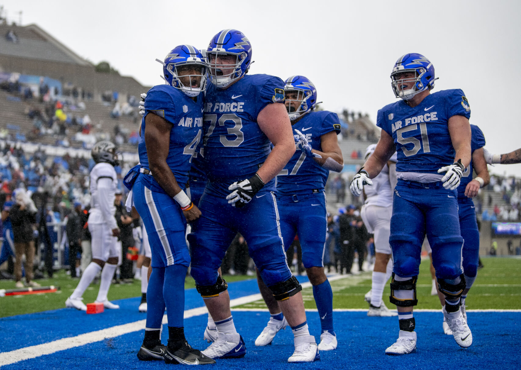 Falcons quarterback Haaziq Daniels, left, celebrates with teammate Isaac Cochran after scoring a touchdown against Colorado this season at Falcon Stadium. (Parker Seibold, The Gazette)