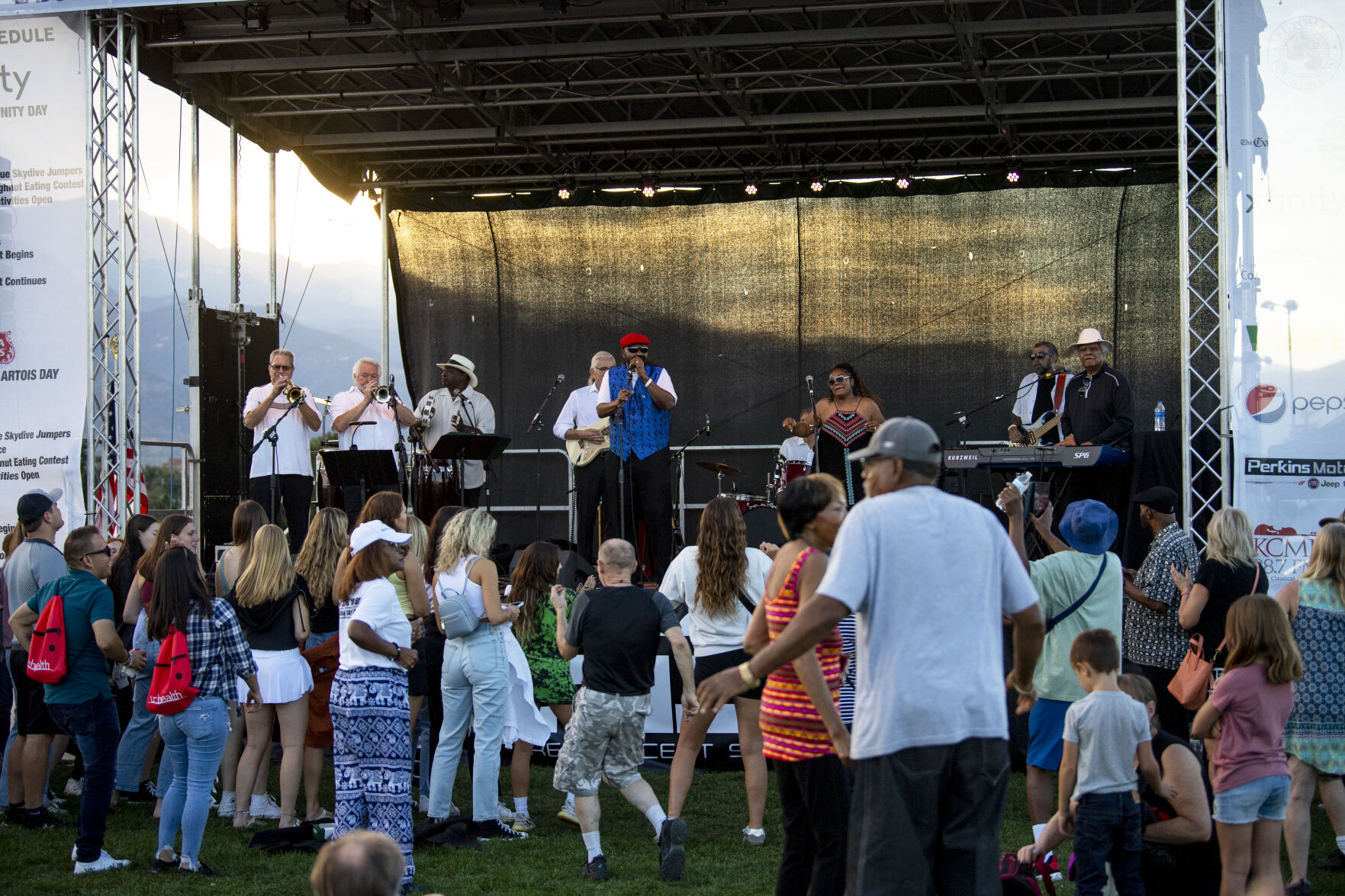 The sun sets as Reminiscent Souls performs for a crowd during Labor Day Lift Off at Memorial Park on Saturday, Sept. 3, 2022. (The Gazette, Parker Seibold) (Parker Seibold/ The Gazette)