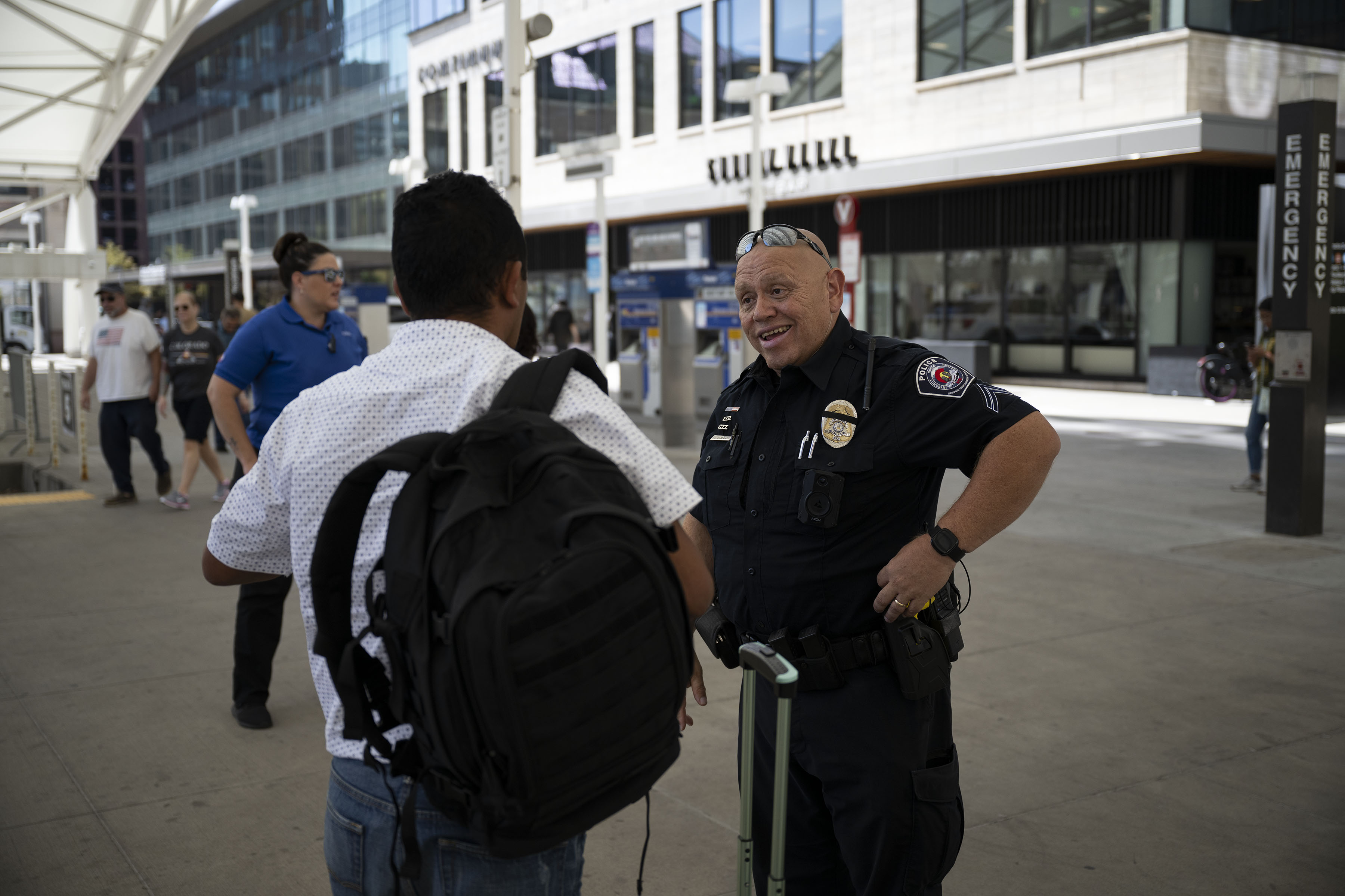 RTD Police Cpl. Conrad Vanegas, who speaks fluent Spanish, helps a traveler from Honduras find the train going toward Thornton on Thursday, Aug. 11, 2022, at Union Station in Denver, Colo. (Timothy Hurst/The Denver Gazette) (Timothy Hurst)