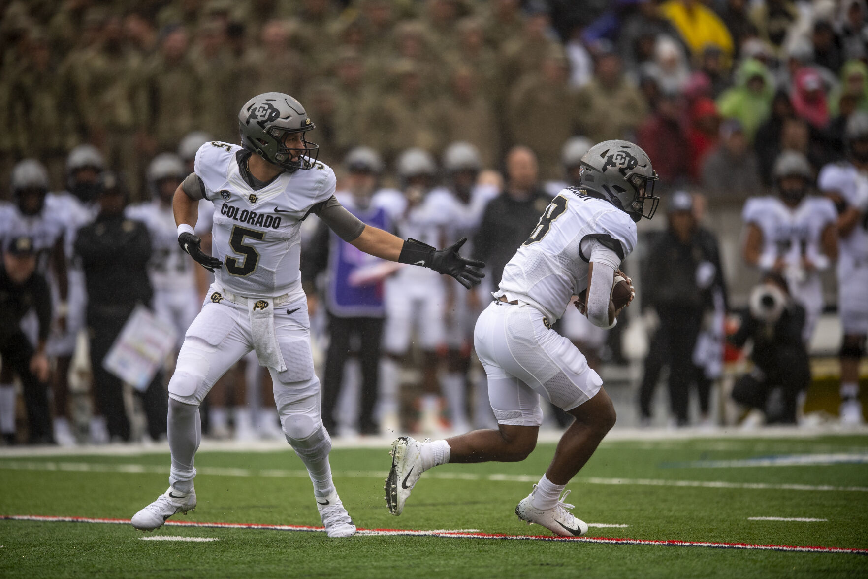 Colorado Buffaloes quarterback J.T. Shrout (5) hands the ball to DUPLICATE***Colorado Buffaloes running back Alex Fontenot (8) during the first quarter of the game against the Colorado University Buffaloes at Falcon Stadium in Colorado Springs, Colo., on Saturday, Sept. 10, 2022. (The Gazette, Parker Seibold) (Parker Seibold/ The Gazette)