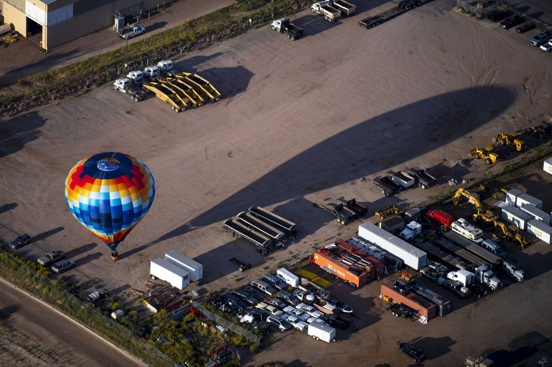 A hot air balloon casts a shadow in an open parking lot as it lands on Friday, Sept. 2, 2022. (The Gazette, Parker Seibold) (The Gazetter Parker Seibold)