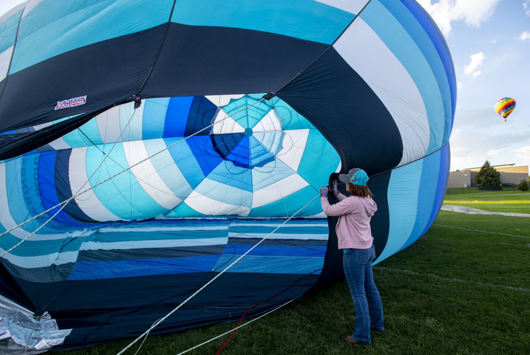 Brynna Wilson holds the side of her husbands balloon before a flight from Memorial Park on Friday, Sept. 2, 2022. (Parker Seibold / The Gazette) (Parker Seibold/ The Gazette)