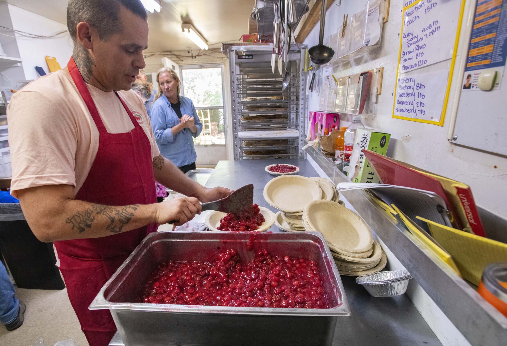 Baker Garrison Gardner fills pies with cherries to make Colorado Cherry Co.'s famous cherry pie Tuesday, Sept. 27, 2022, at the Lyons restaurant. (The Gazette, Christian Murdock) (Christian Murdock/The Gazette)