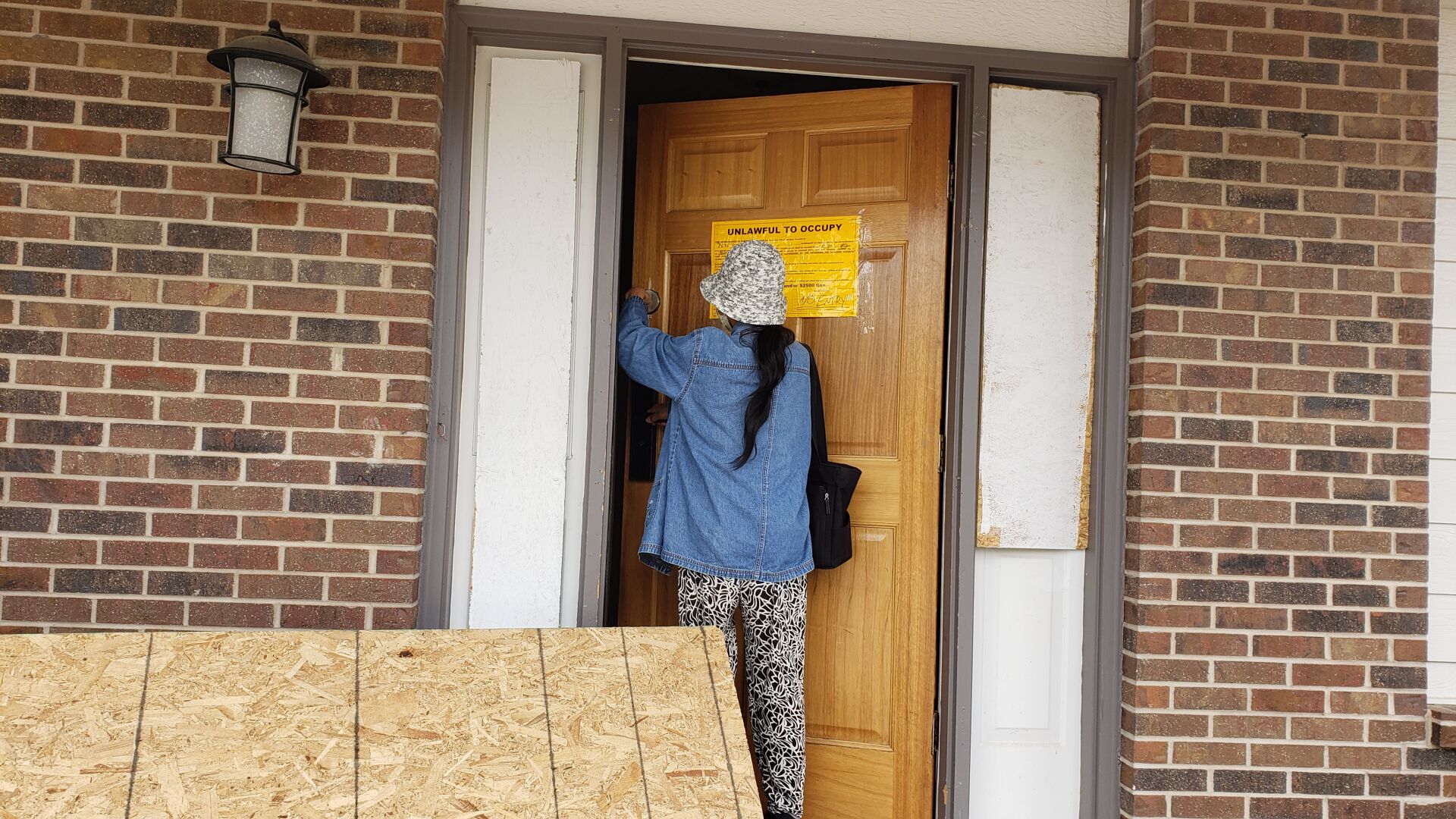 B. Lin enters her condemned home to show the extent of the damage that squatters caused while she was out of town. (Debbie Kelley, The Gazette)