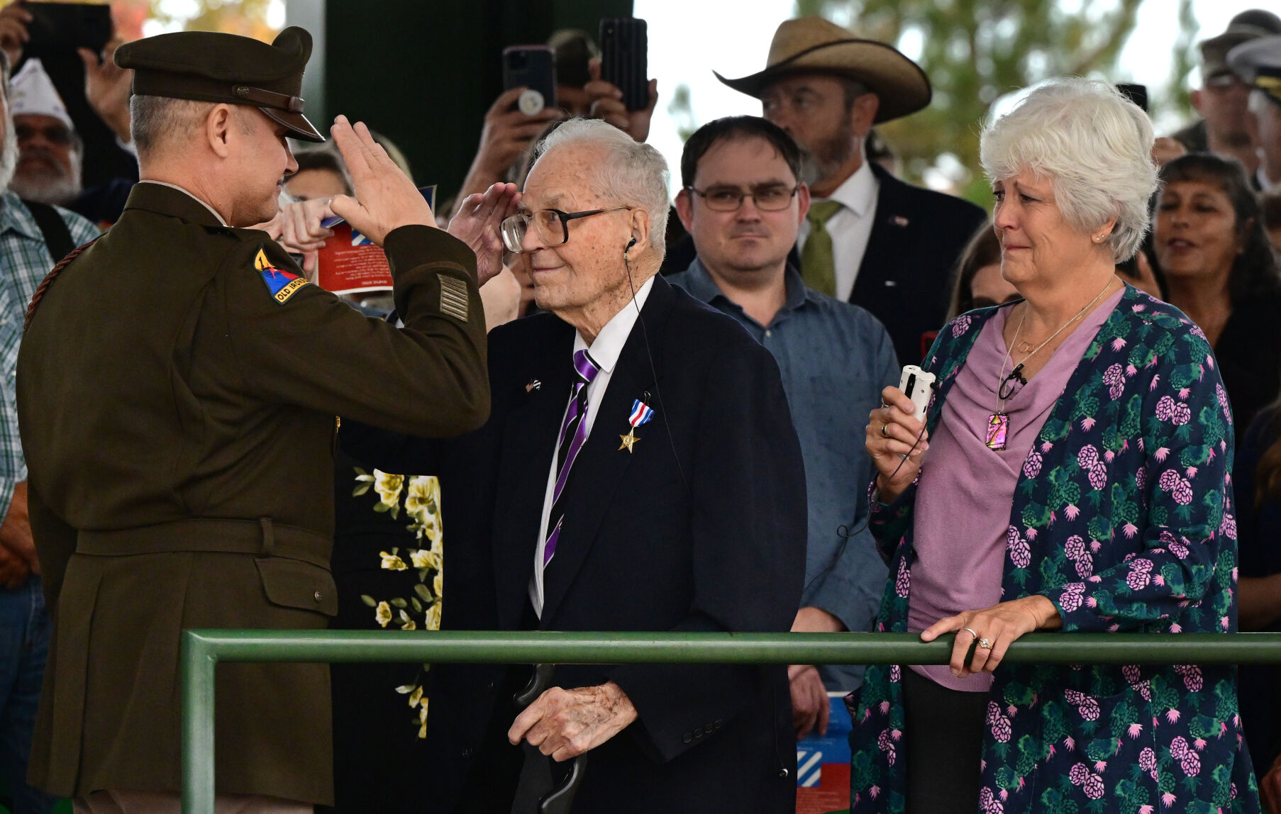 World War II veteran Sergeant First Class Harold Nelson salutes back to Maj. Gen. Charles Costanza, Commanding General of the 3rd I.D., after receiving the Silver Star during a ceremony at Ft. Carson on Tuesday, Oct. 4, 2022. Nelson’s daughter, Carolee Soden (right), was emotional to see this day finally arrive. Nelson, 107 and a resident of Denver, was drafted into the United States Army in 1941 from Fort Crook, Nebraska. (Photo by Jerilee Bennett, The Gazette) (Jerilee Bennett, The Gazette)