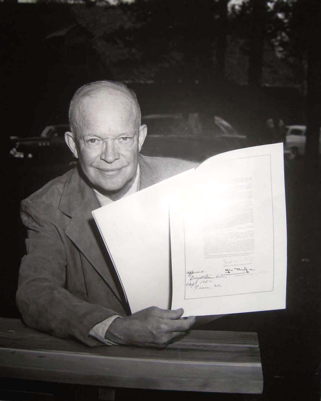 President Dwight D. Eisenhower signs a bill into law while vacationing at Byers Creek Ranch near Fraser, Colo. The ranch recently traded hands for $11.5 million. (COURTESY OF THE GRAND COUNTY HISTORICAL ASSOCIATION)